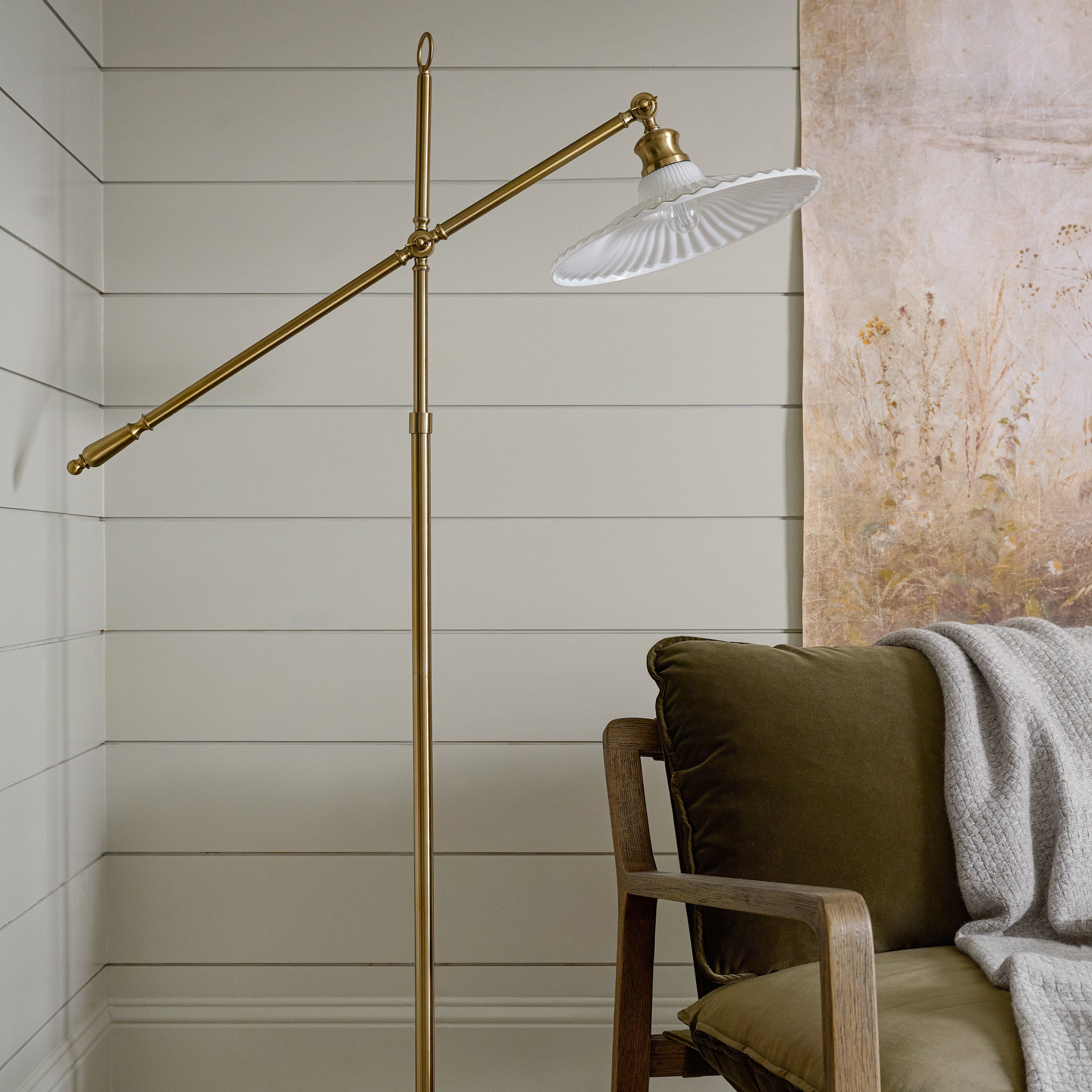 Marjorie Milk Glass Floor Lamp shown in corner of room over chair