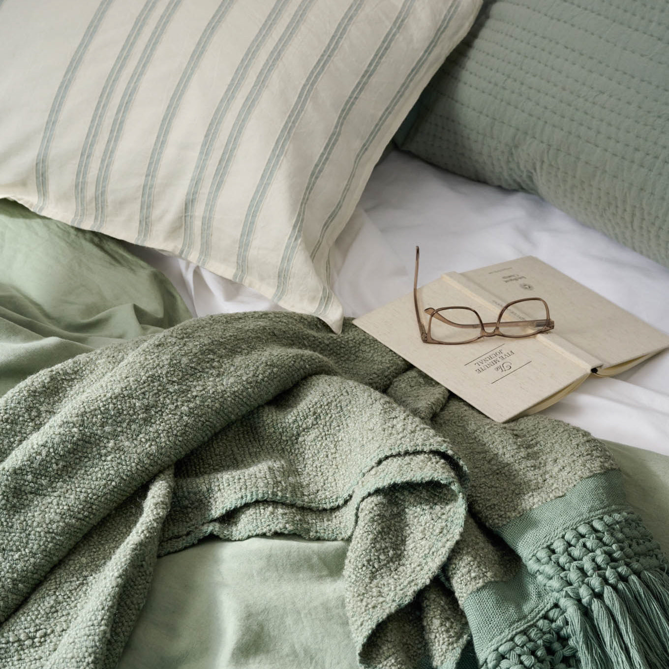 Embroidered Chambray Stripe Linen Cotton Pillow Sham on a bed