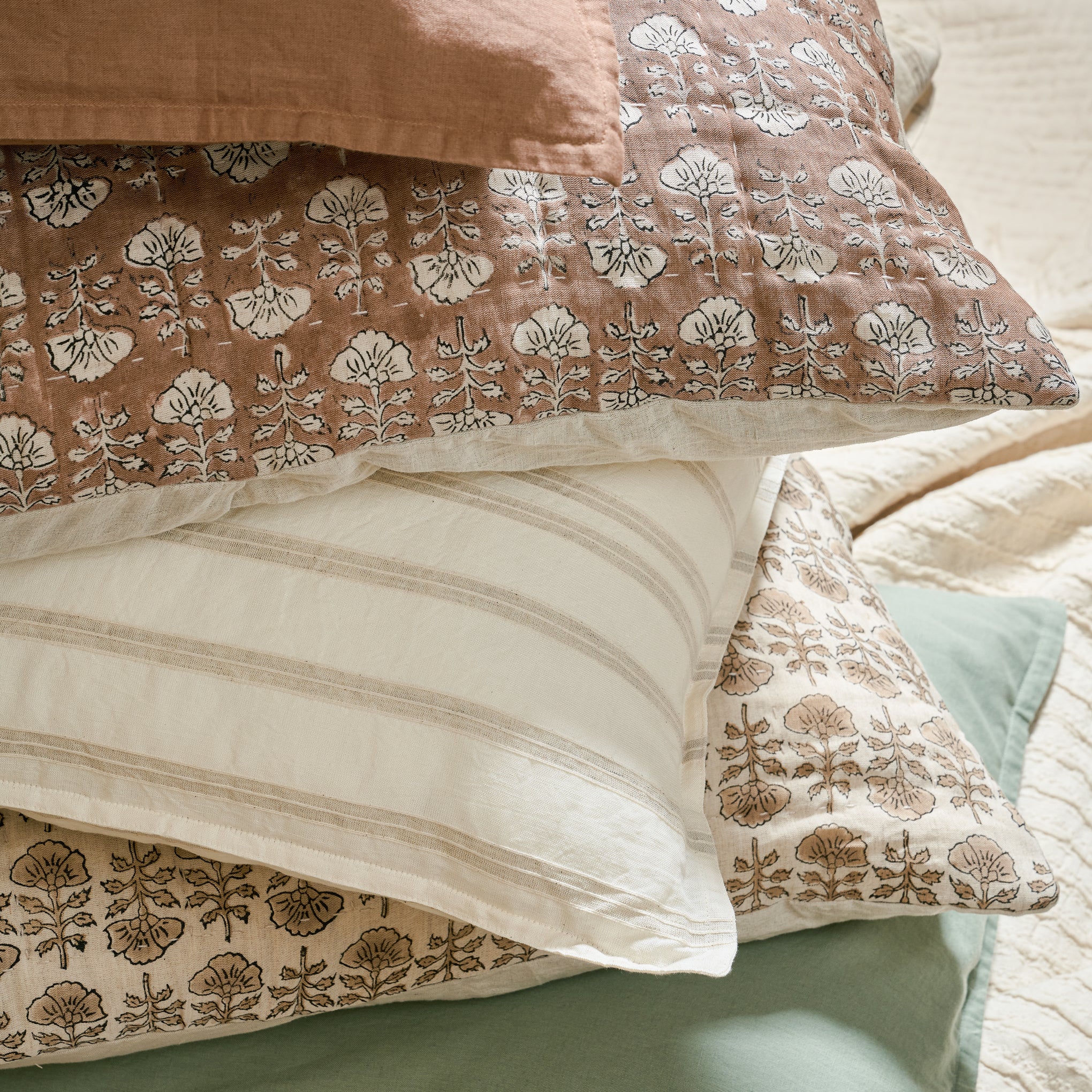Stacked pillows with flora block desert clay pillow sham