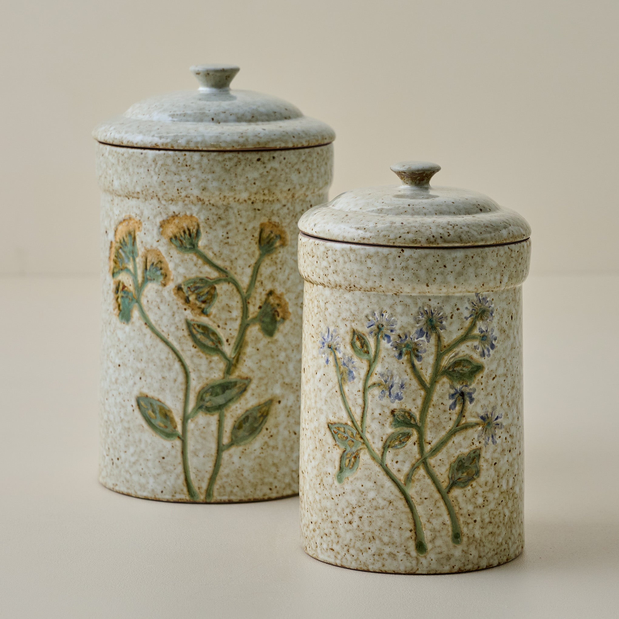 Golden Wildflower Canister shown with another canister with blue wildflowers