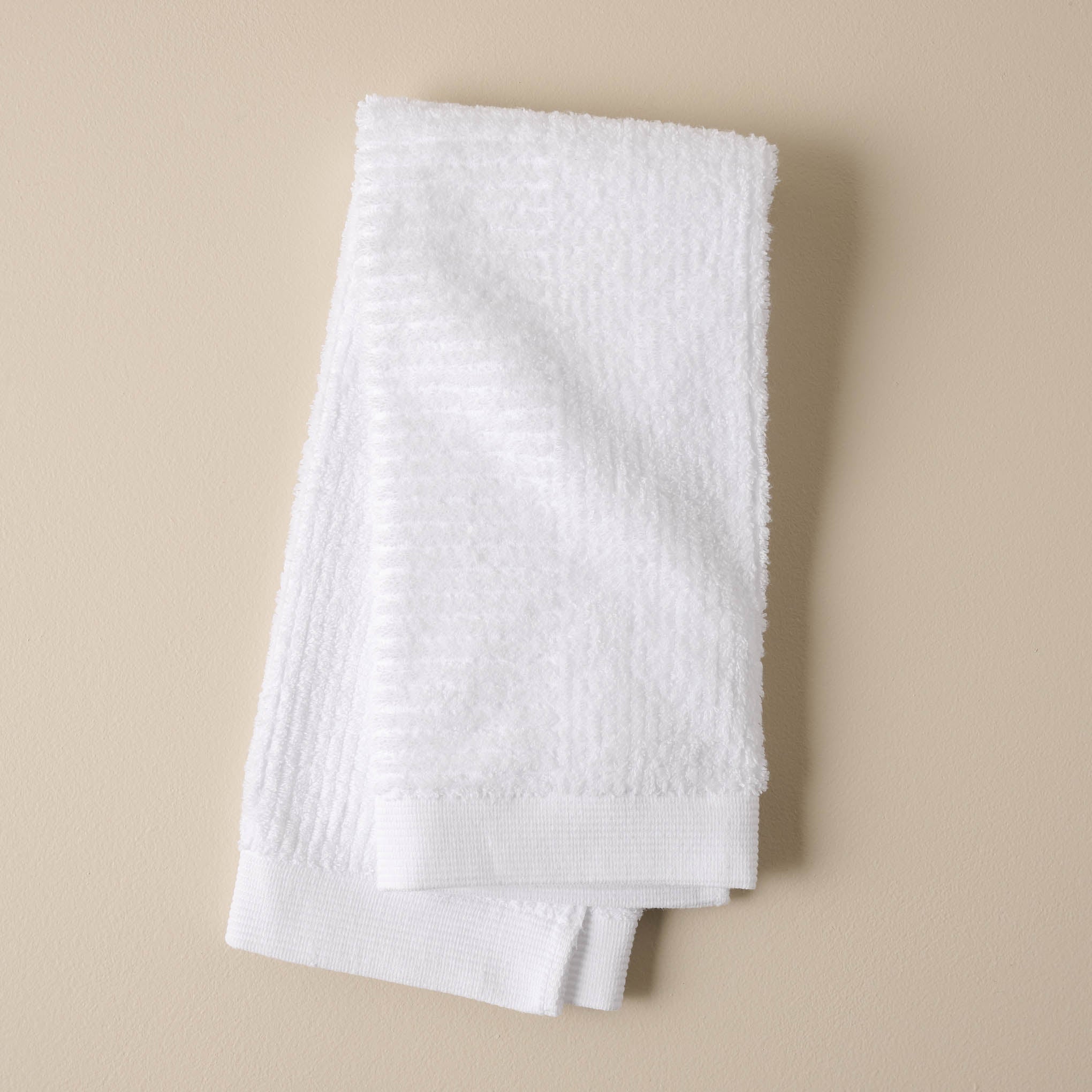 folded white textured hand towel