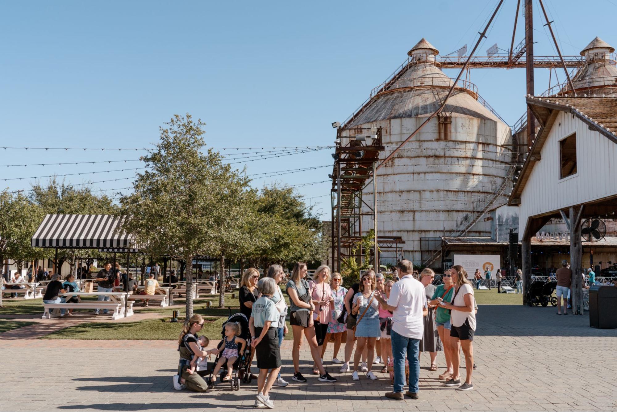 Group of people listening to tour guide next to Magnoliass Silos