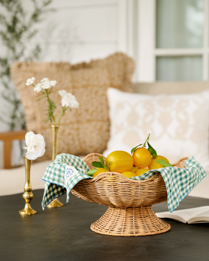 Wicker basket with lemons on a table, with a blurred indoor background
