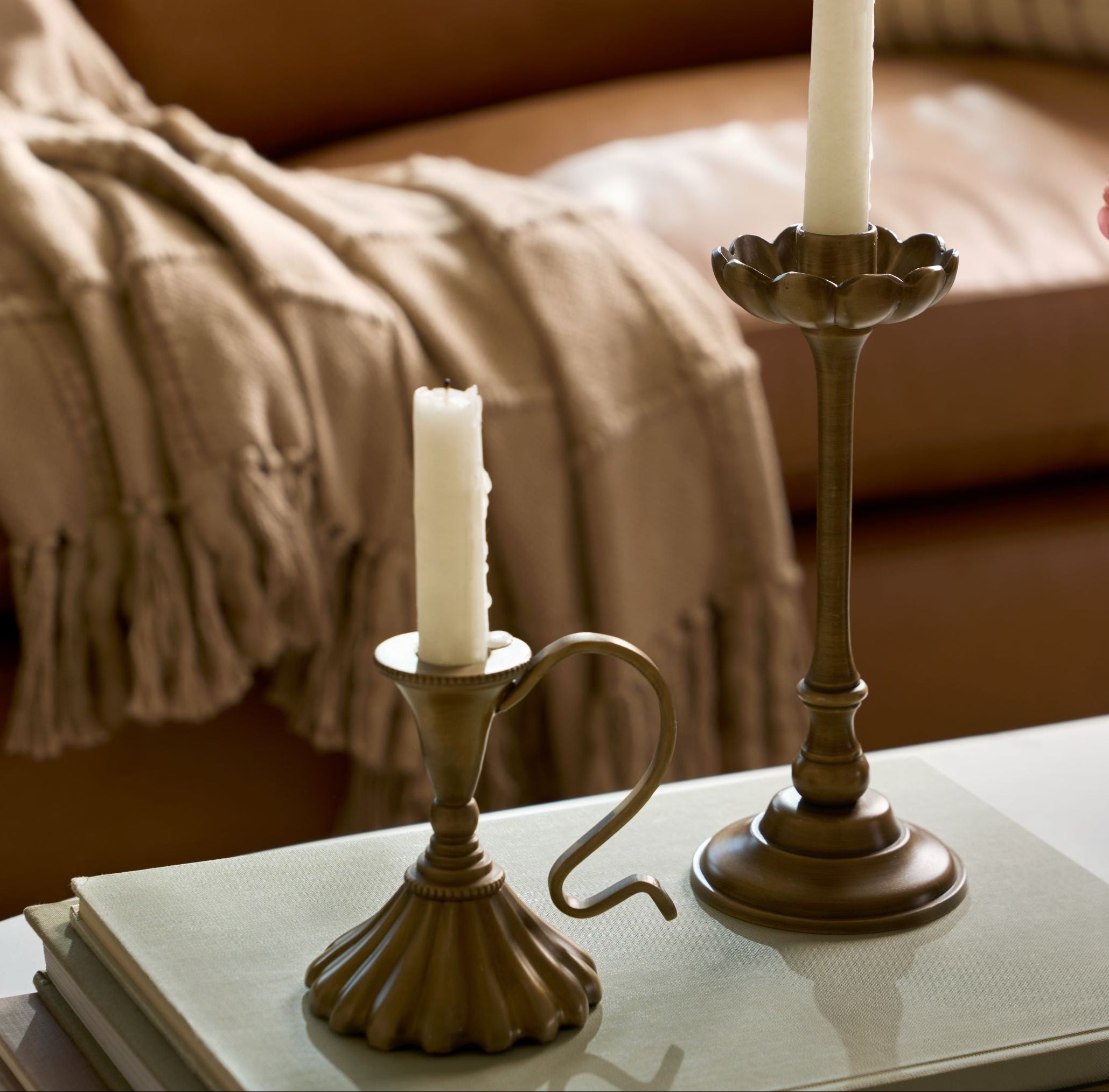 Anna Antique Brass Taper Holders set on coffee table