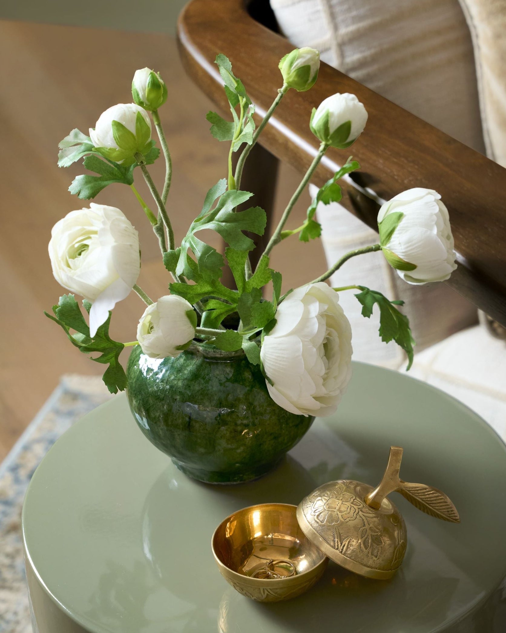 Round Blair Crackle Glaze Bud Vase with white ranunculus displayed on green end table
