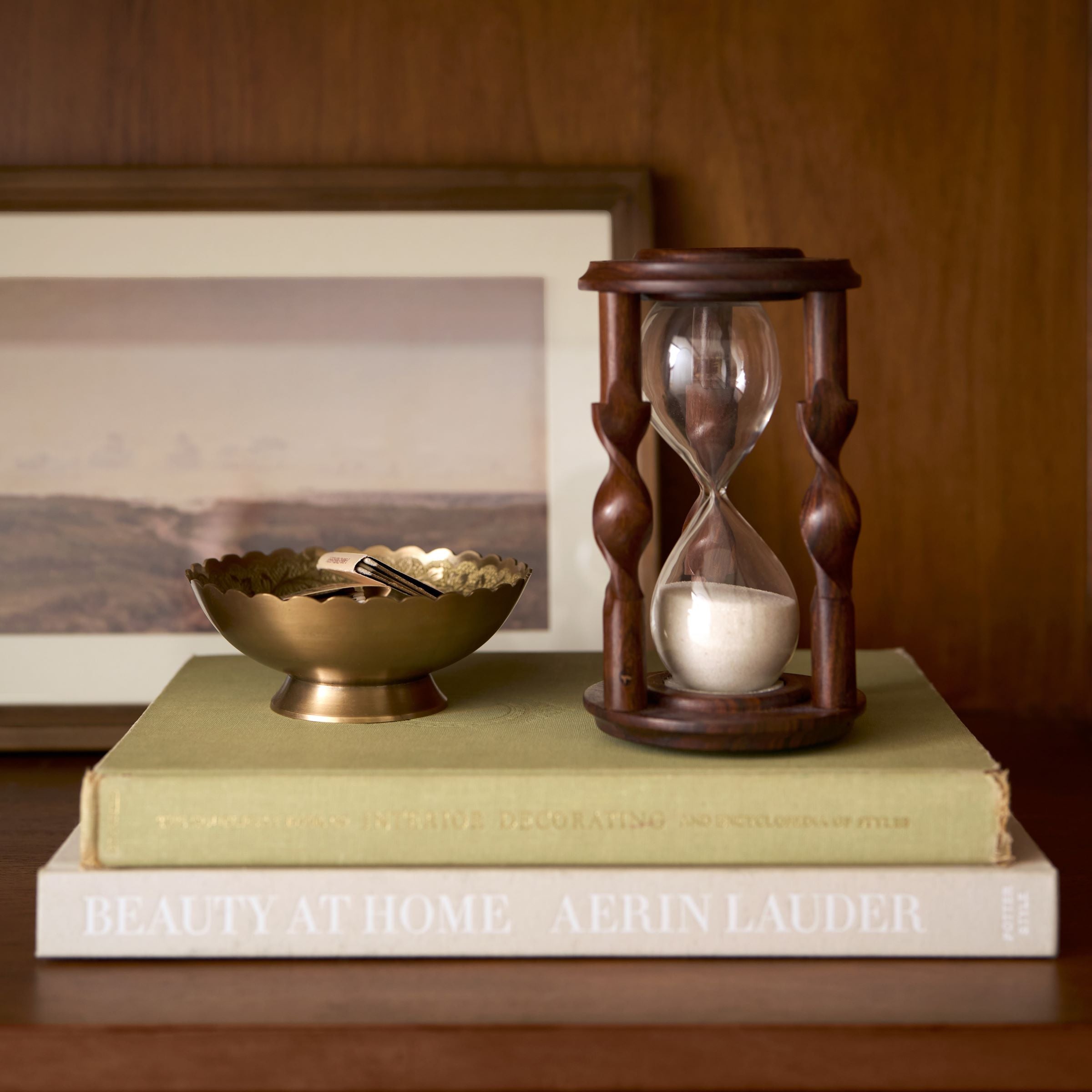 Barley Twist Hourglass set on stack of books next to brass bowl