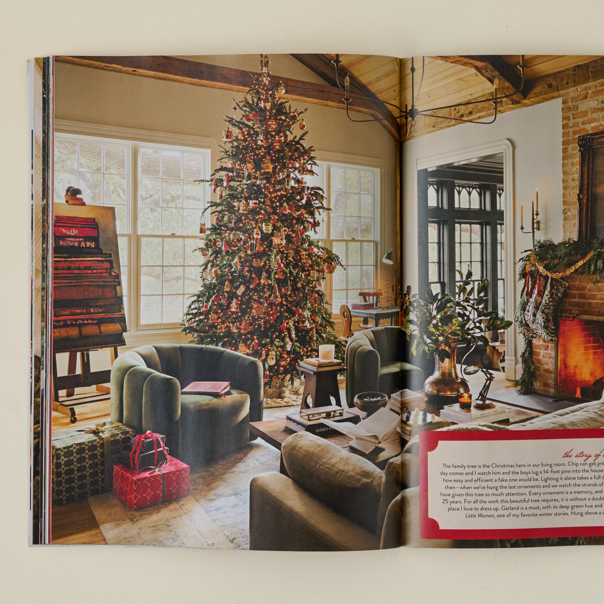 Magnoliass 2025 Winter Journal photo captured of Christmas-themed living with wrapped presents, lit up Christmas tree and wood-burning fireplace