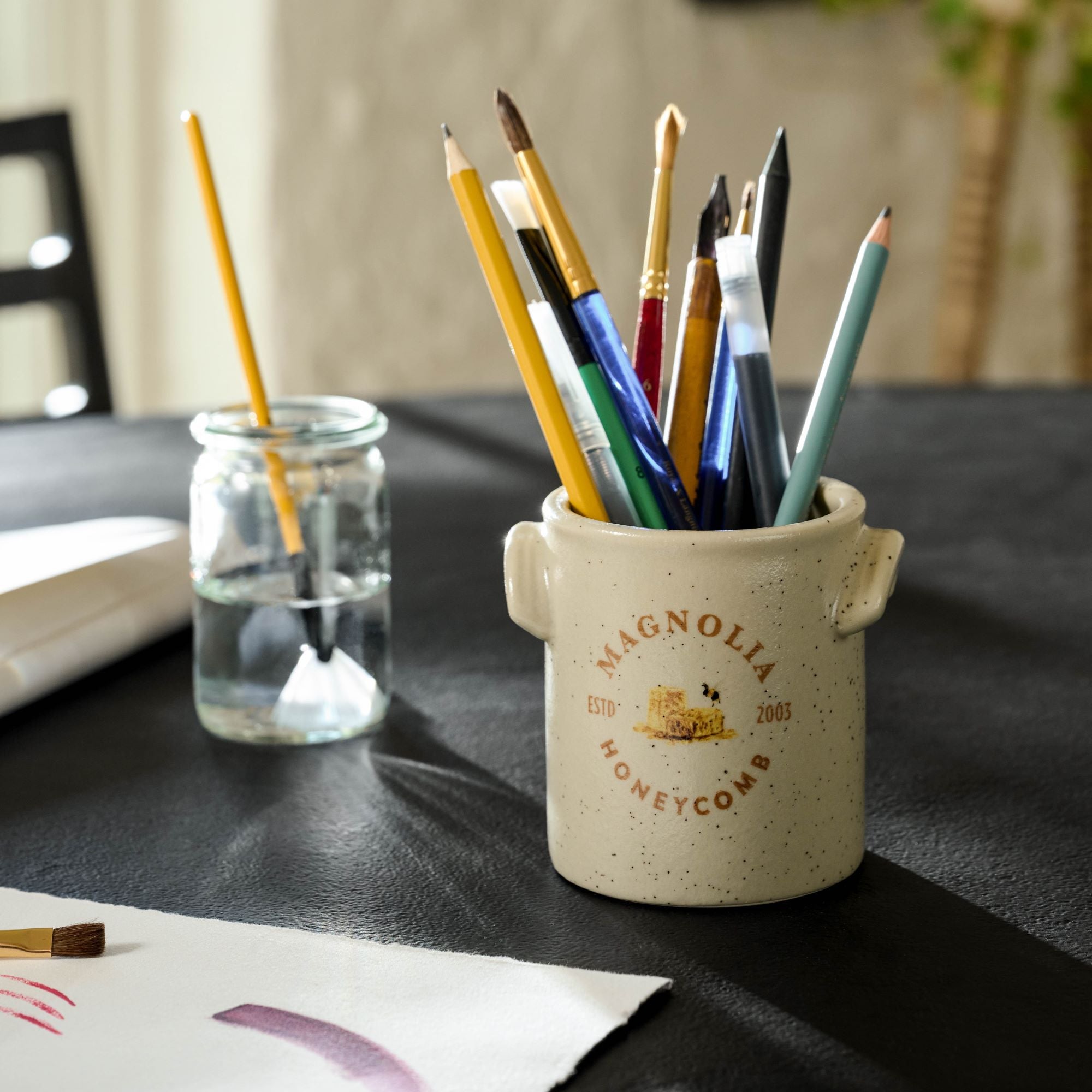 Magnoliass Honeycomb Candle emptied and used as paintbrush holder