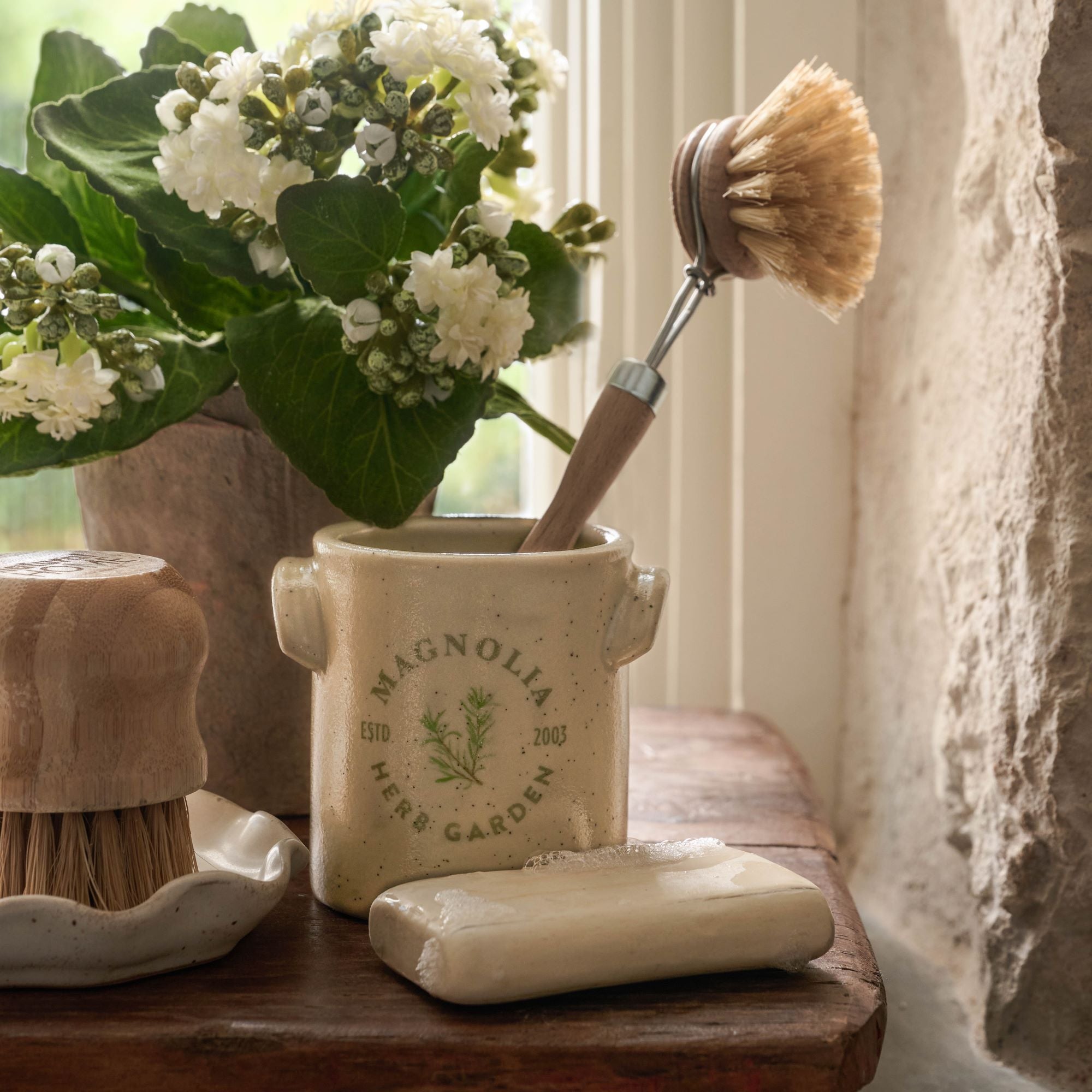 emptied Magnoliass Herb Garden Candle with dish brush 