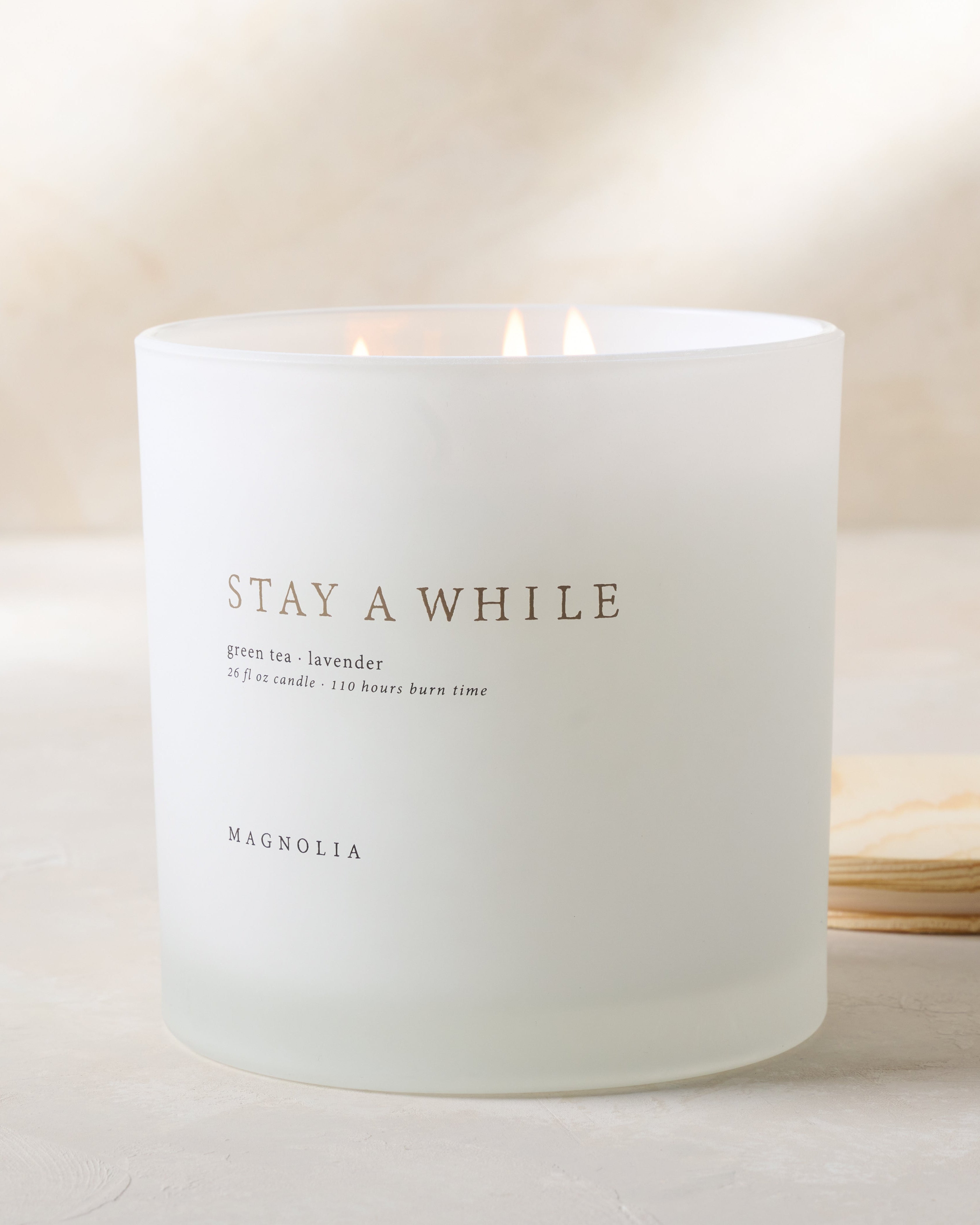 Magnoliass stay a while candle with wood lid notes scents of green tea and lavender