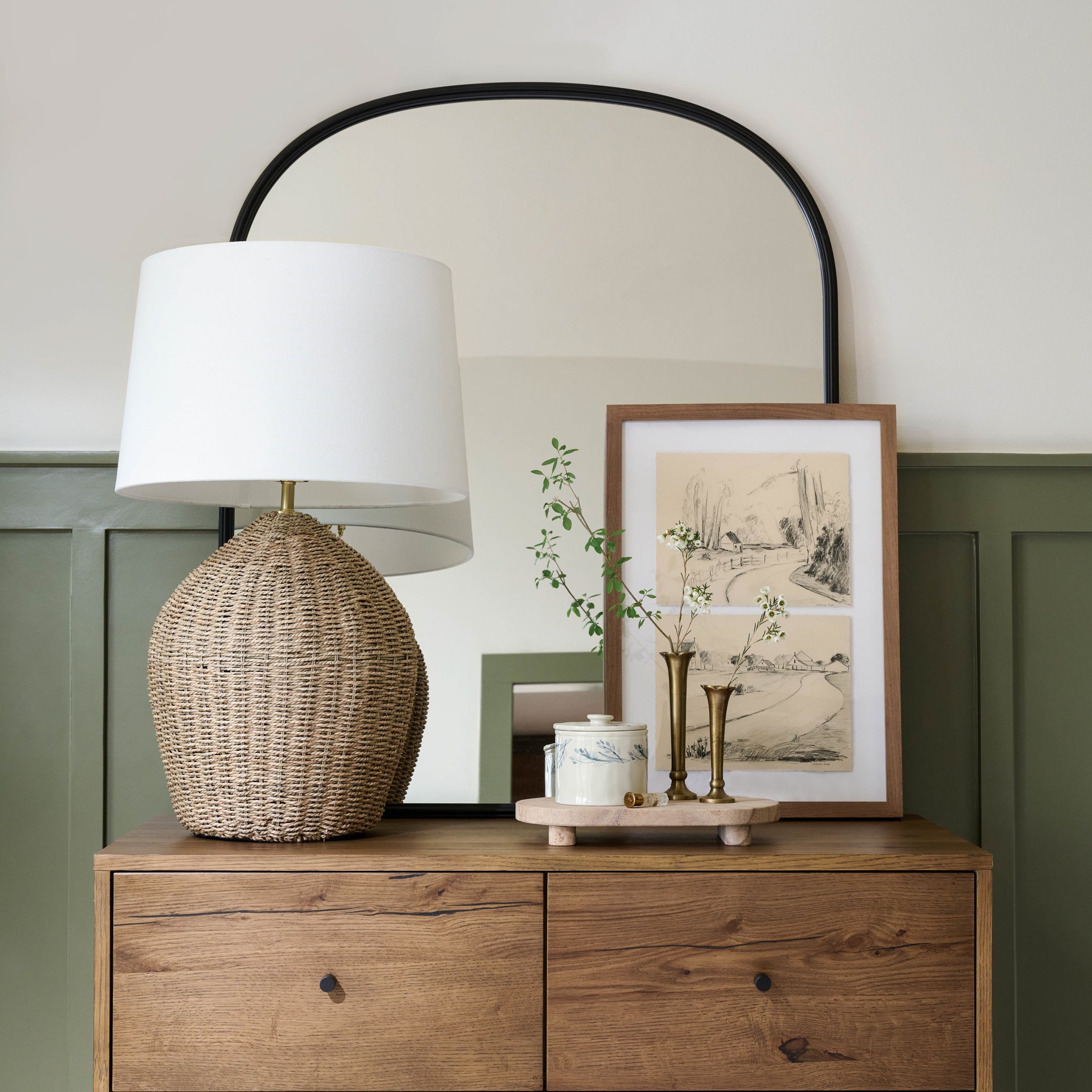 Flannery Scalloped Brass Bud Vase on dresser with greenery 