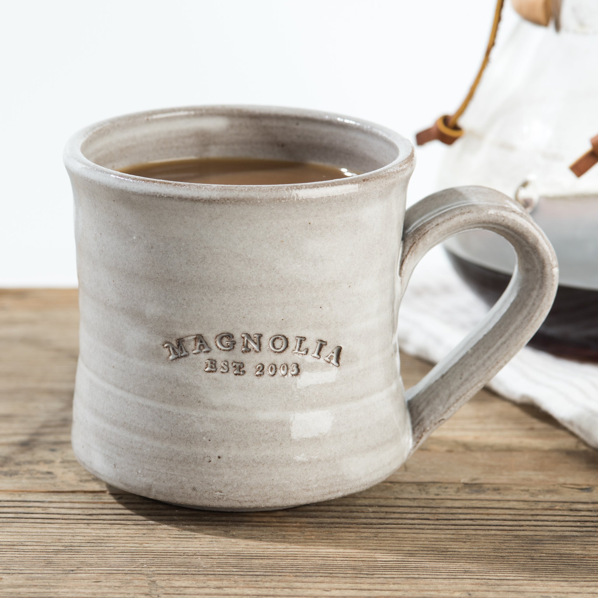 hand-thrown grey mug with Magnoliass established stamp 
