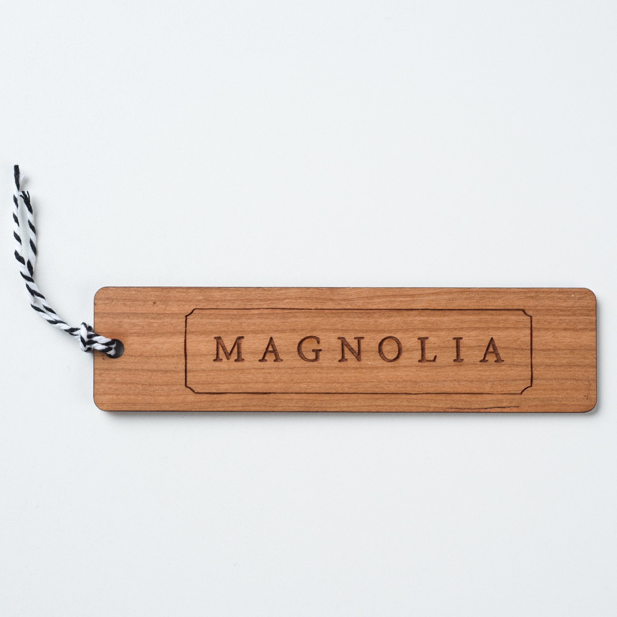 wooden bookmark with Magnoliass logo