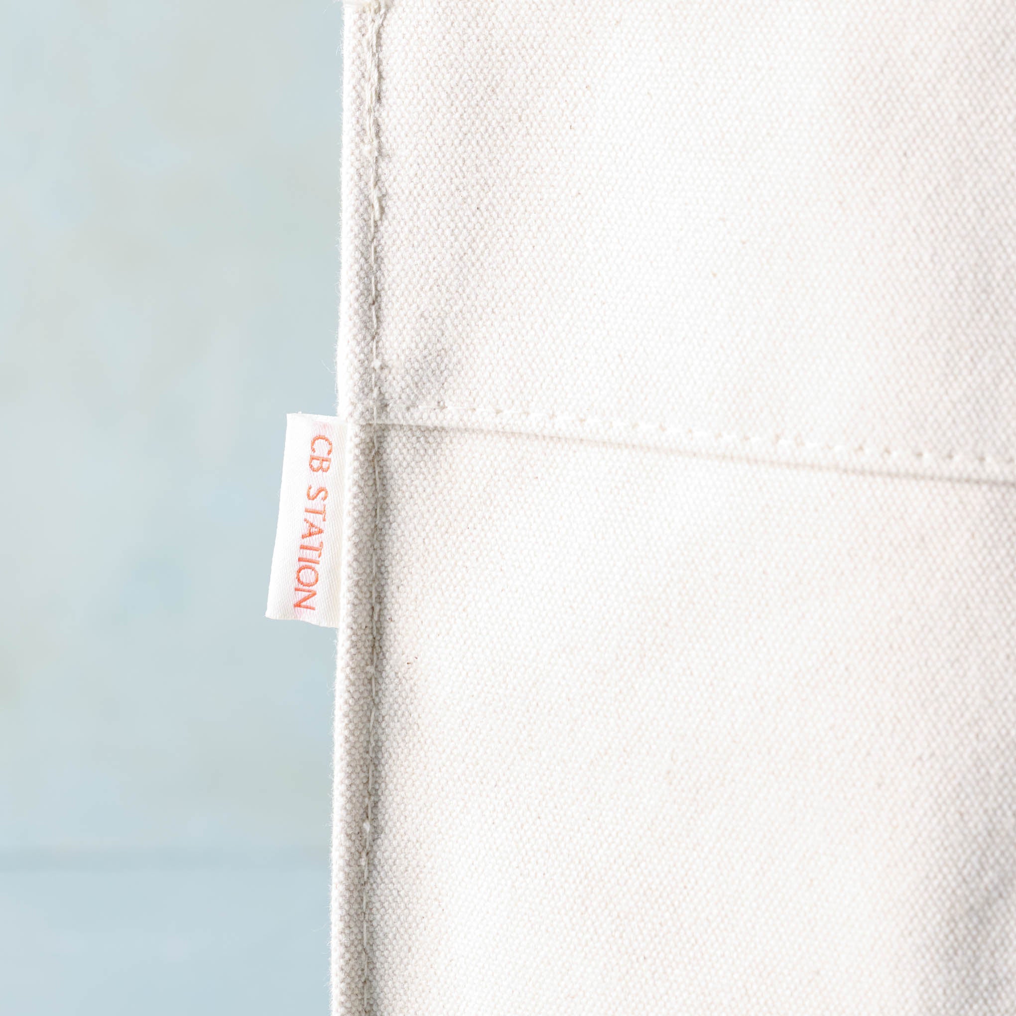 close up of CB Station tag on Magnoliass Cora Script Large Canvas Tote
