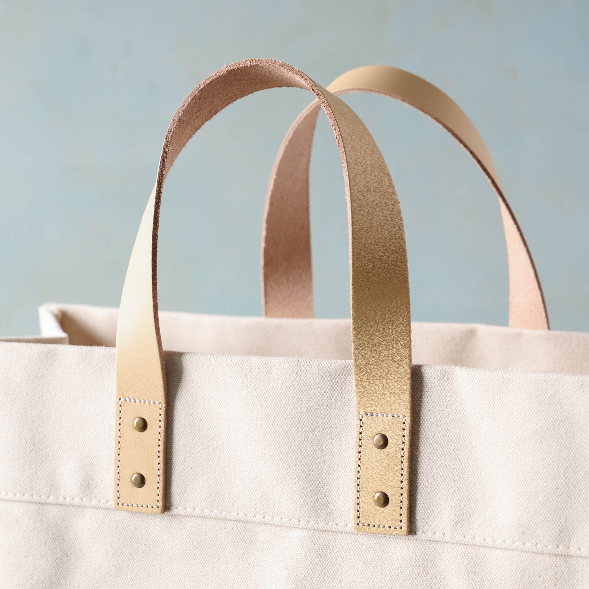 Close up of handles on Magnoliass Cora Script Large Canvas Tote