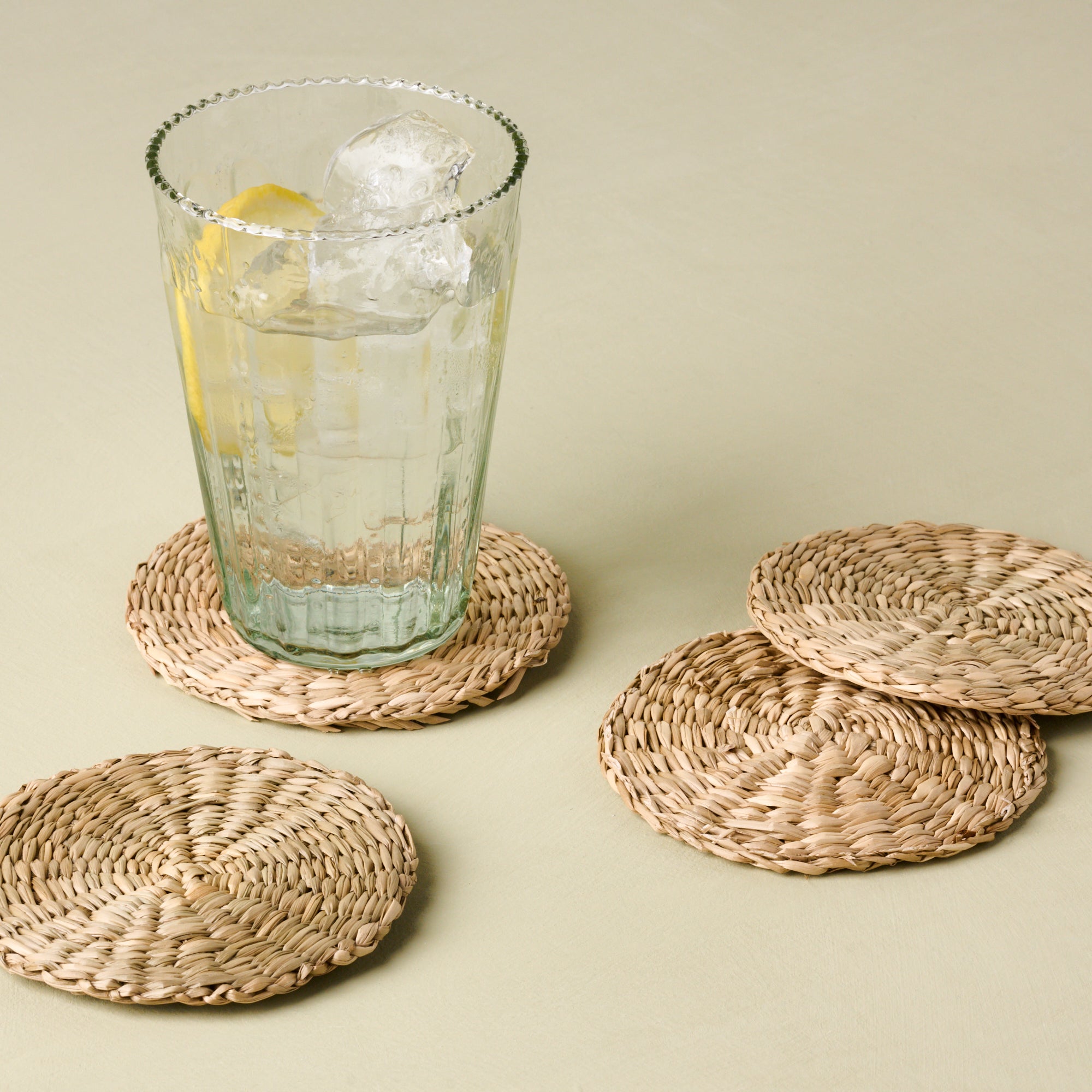 Magnoliass elizabeth bottle cut glass tumbler in tall size on wicker coaster