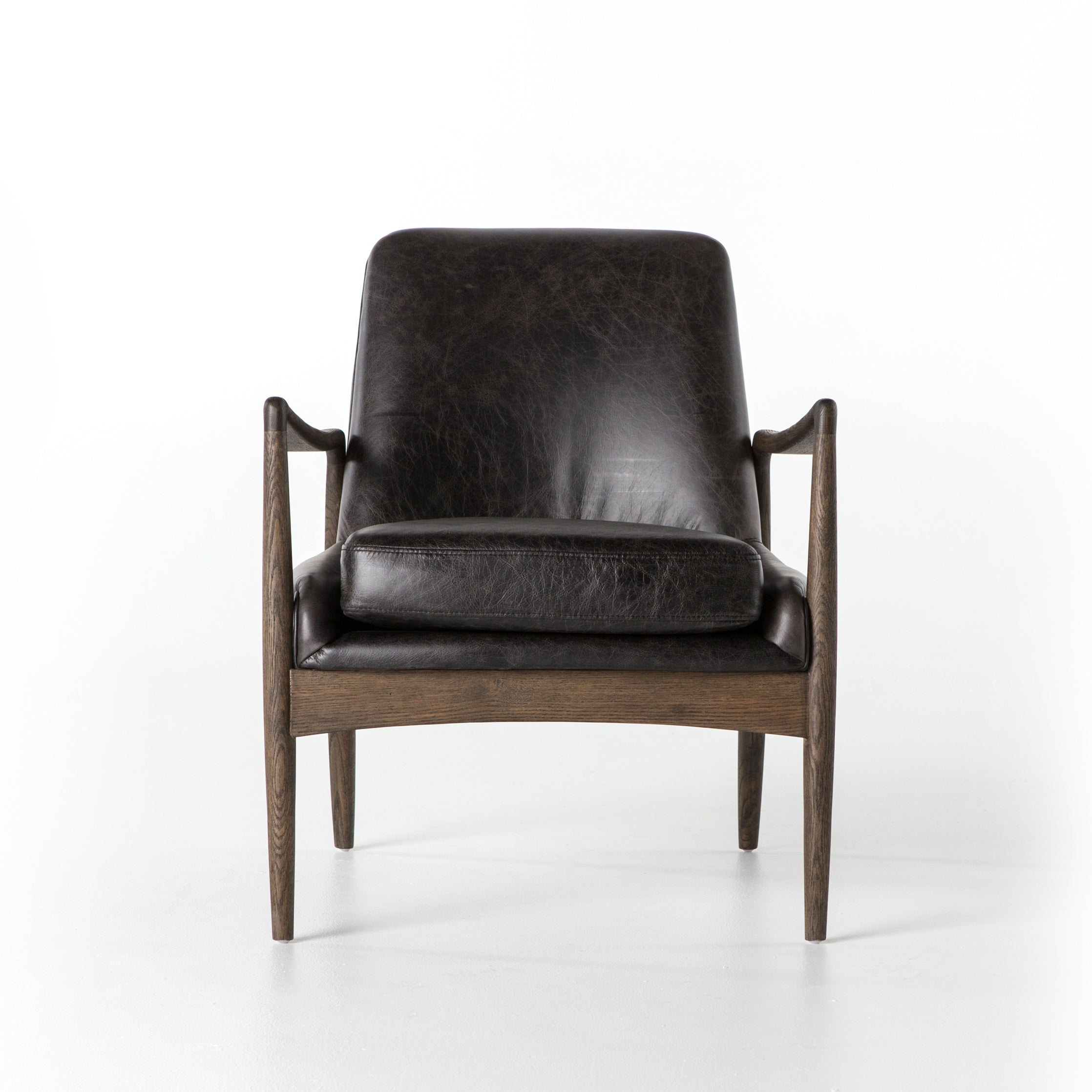 distressed black leather mid century modern arm chair with wooden arms and legs