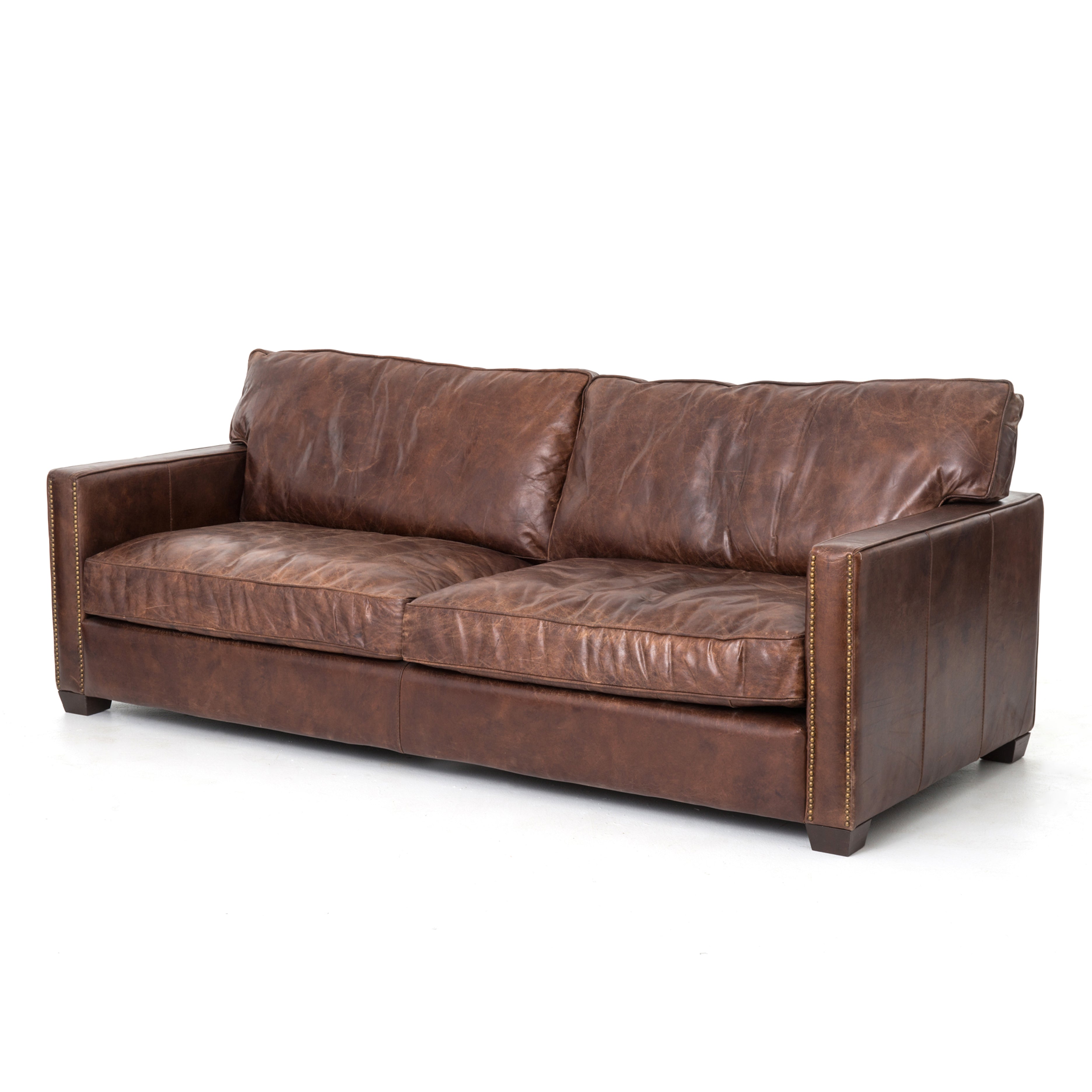 medium brown leather sofa with nailhead arms