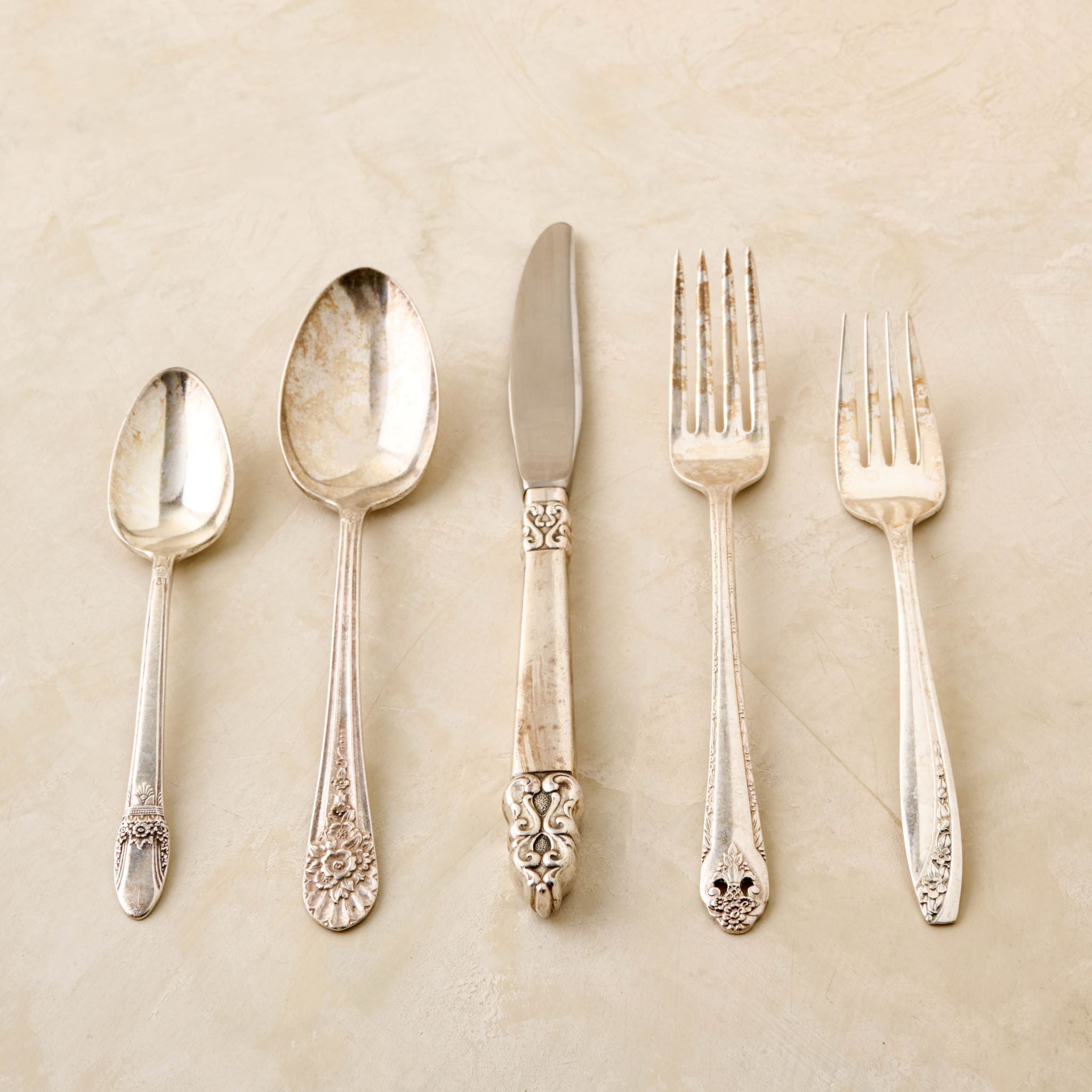 Magnoliass vintage flatware set including fork, knife, and spoon