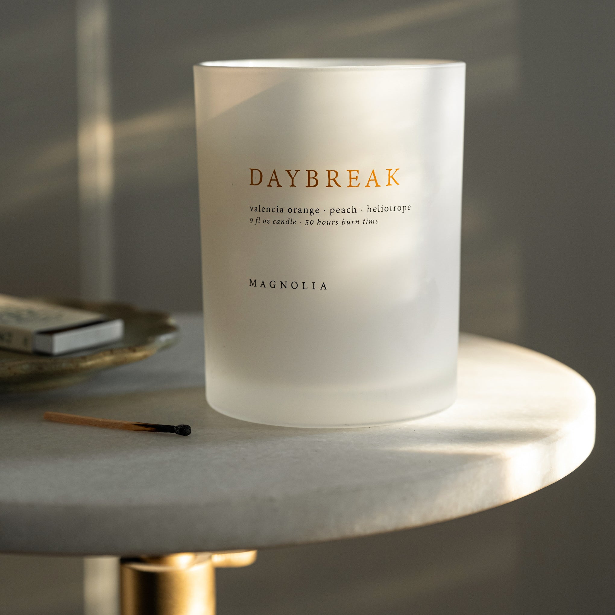 Magnoliass Daybreak Candle on a side table