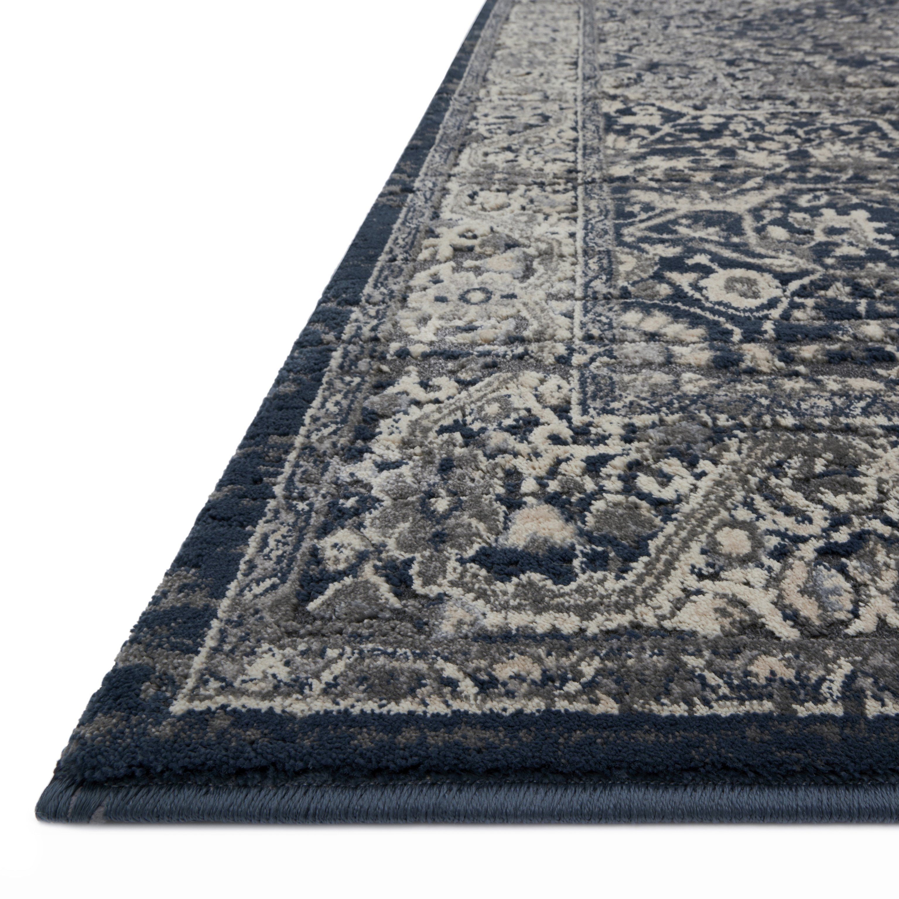 dark charcoal rug with light grey detail and traditional pattern