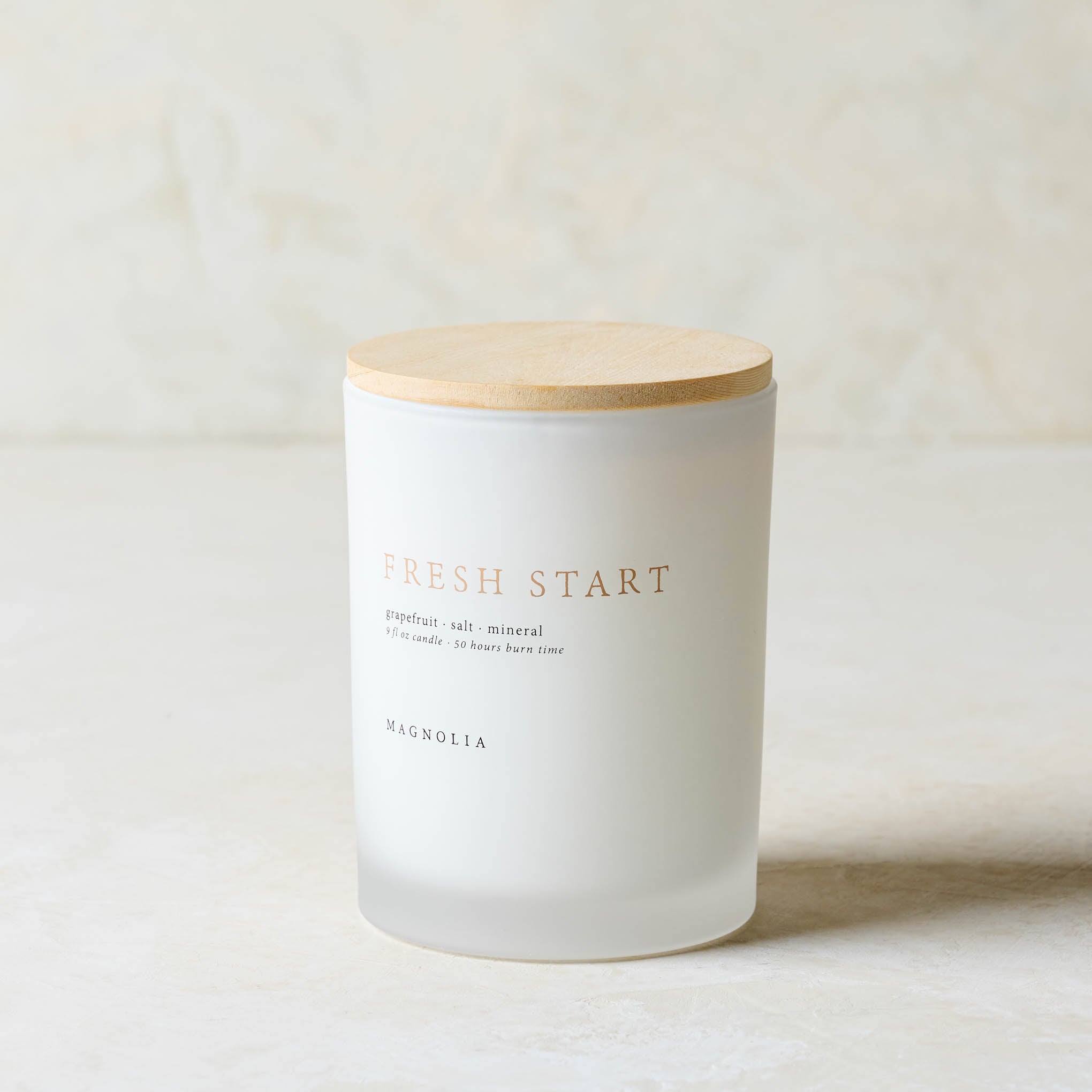 Magnoliass fresh start candle with wood lid notes scents of grapefruit salt and mineral