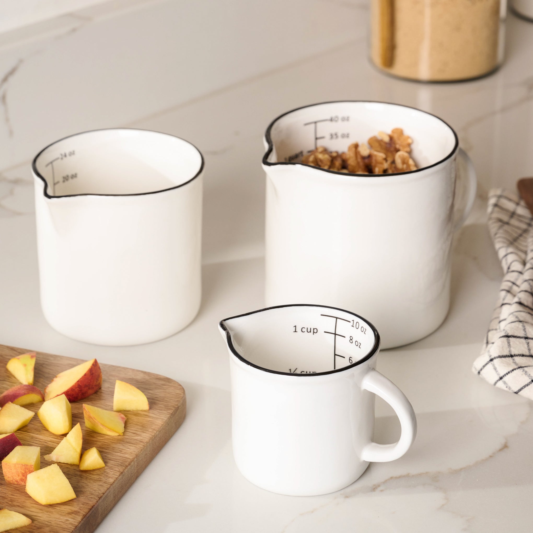 Magnoliass Black Rim Measuring Pitcher in three sizes on countertop