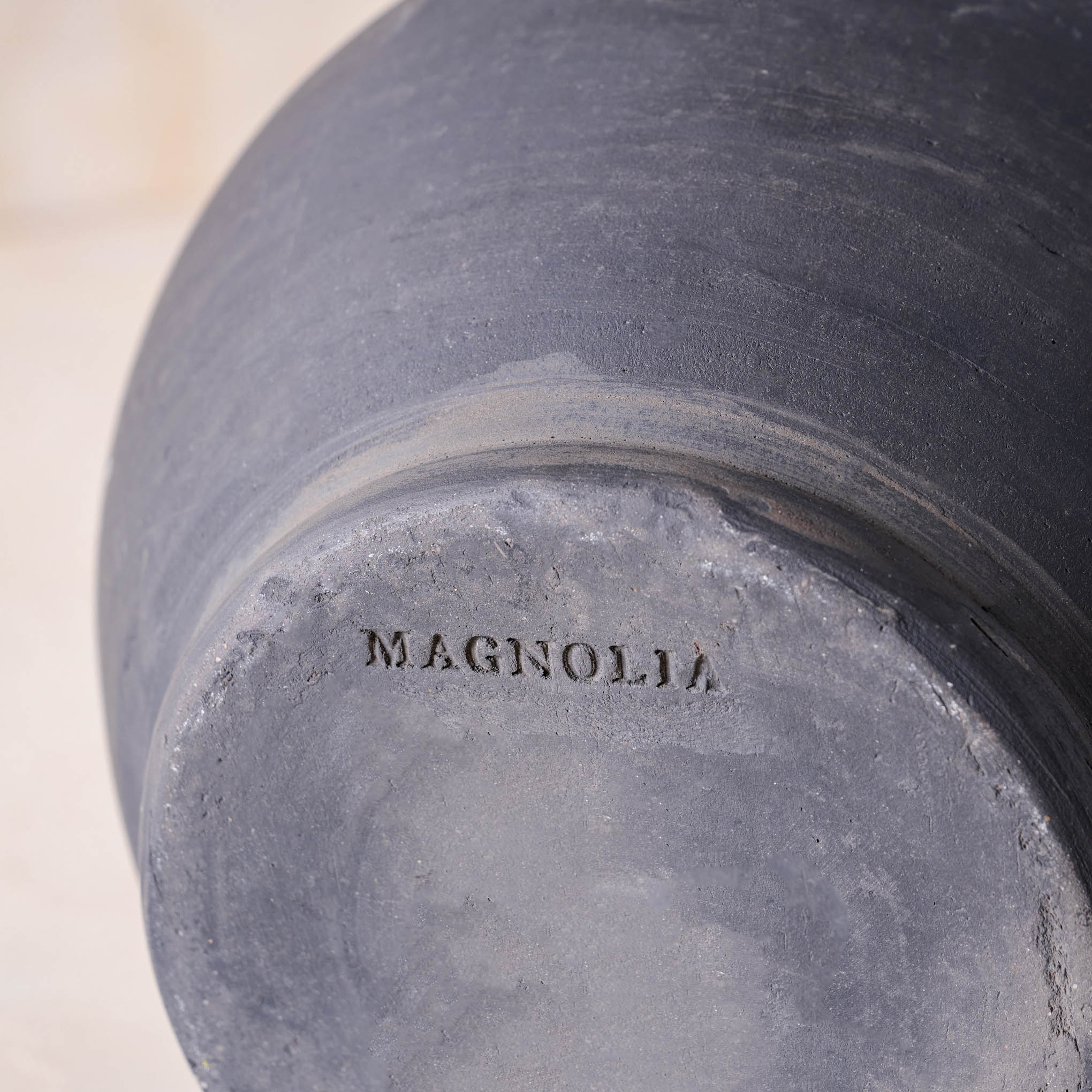 Magnoliass logo embossed on the bottom of Rustic Black Hand-Made Vase