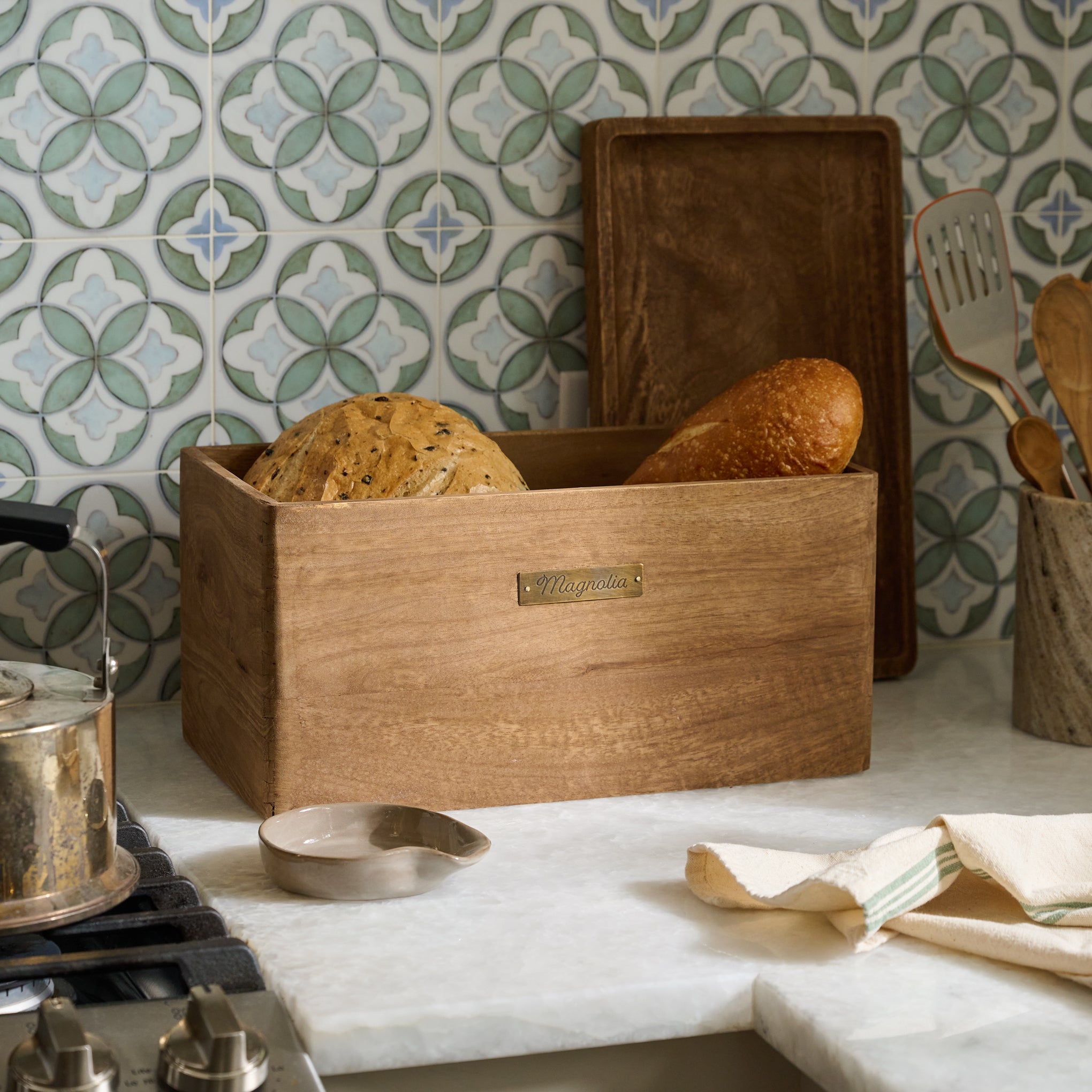 Magnoliass Antiqued Wood Storage Box on counter containing bread