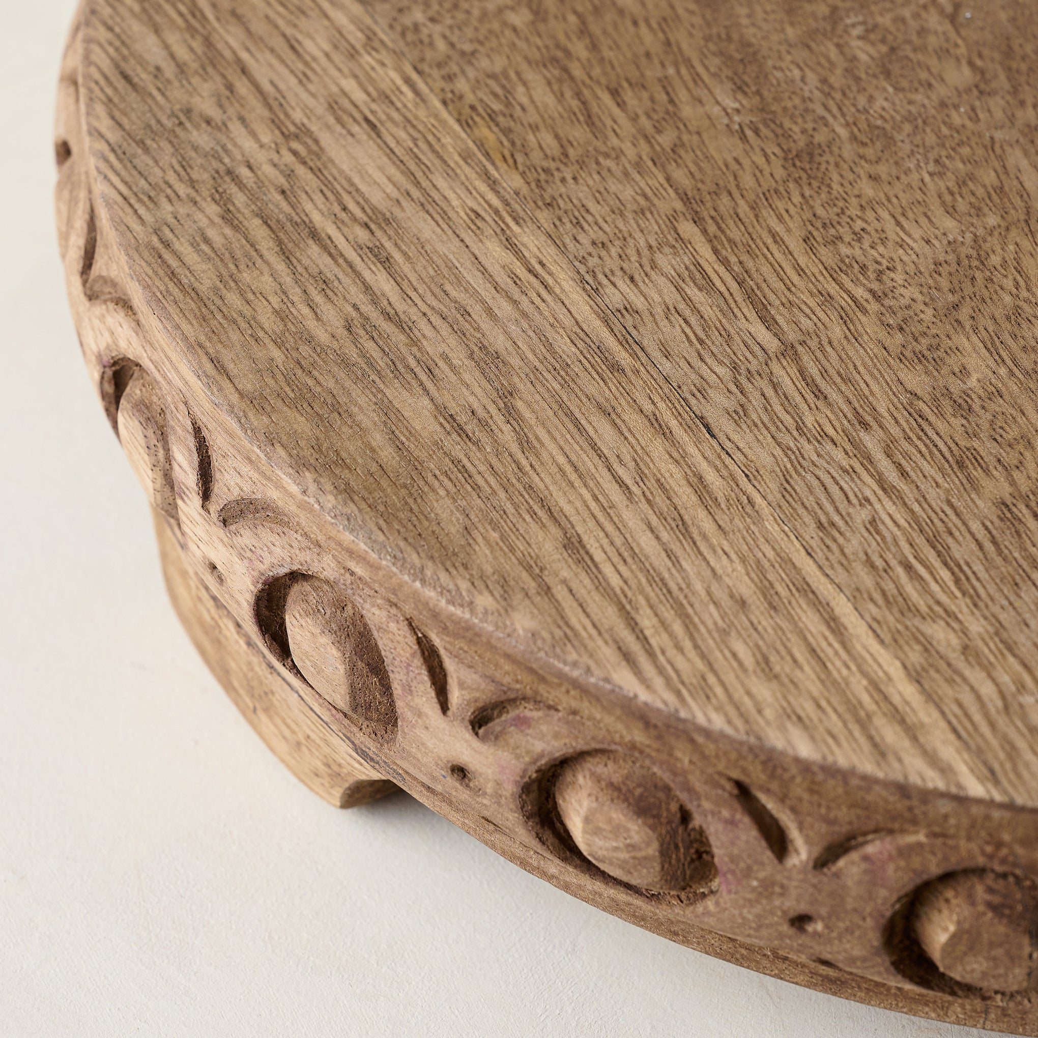 Antiqued Carved Wood Round Riser close up 