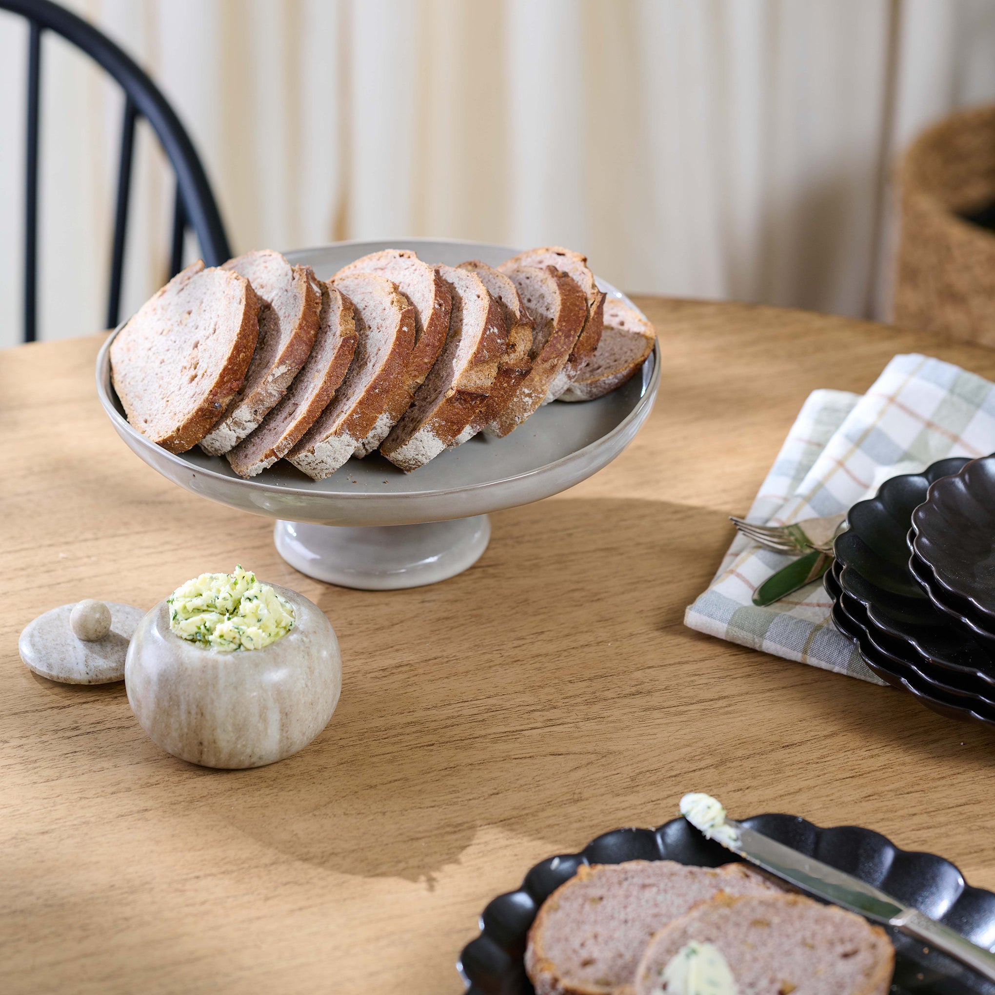 Black Scalloped Plate on table in dining room setting
