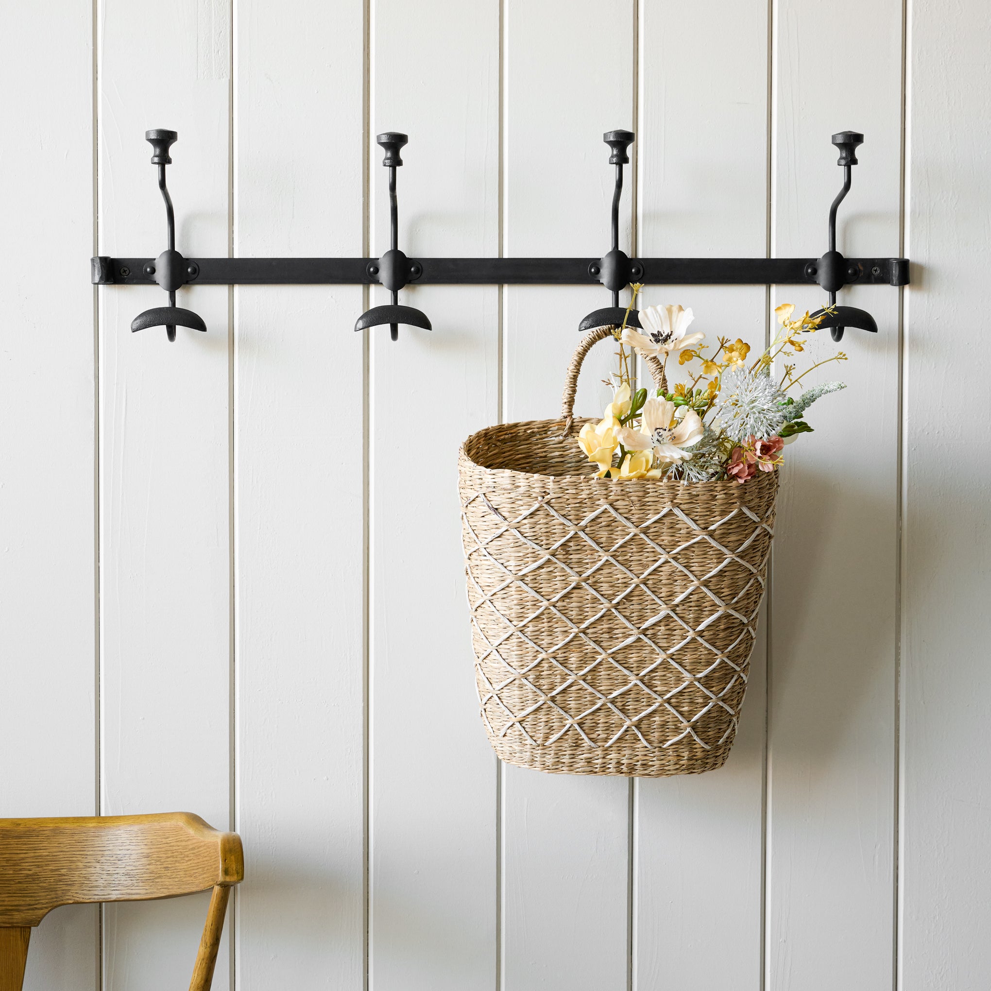 Long duke metal wall hook pictured with wicker basket hanging from one hook.