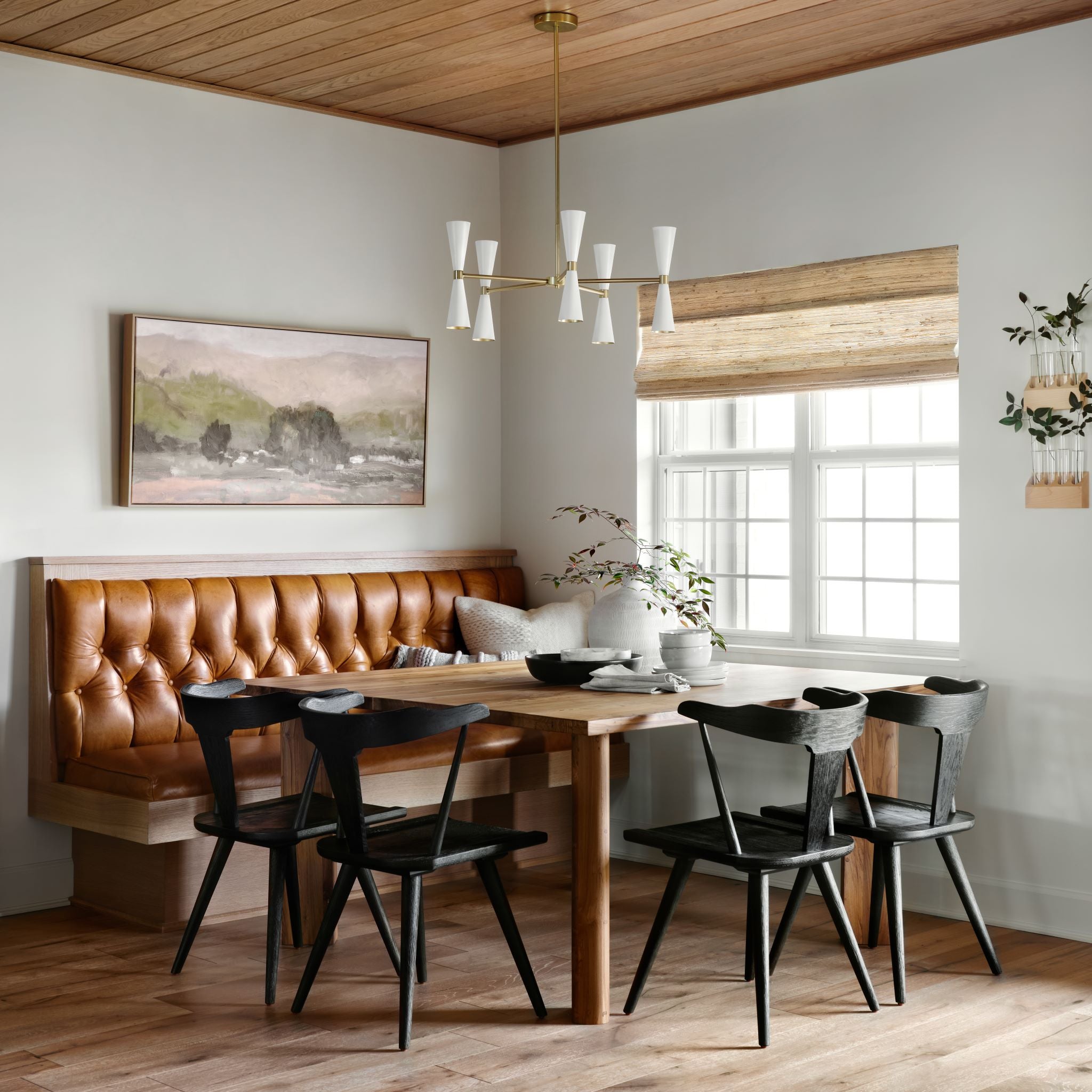 framed wall art called the valley hung on wall above dining table