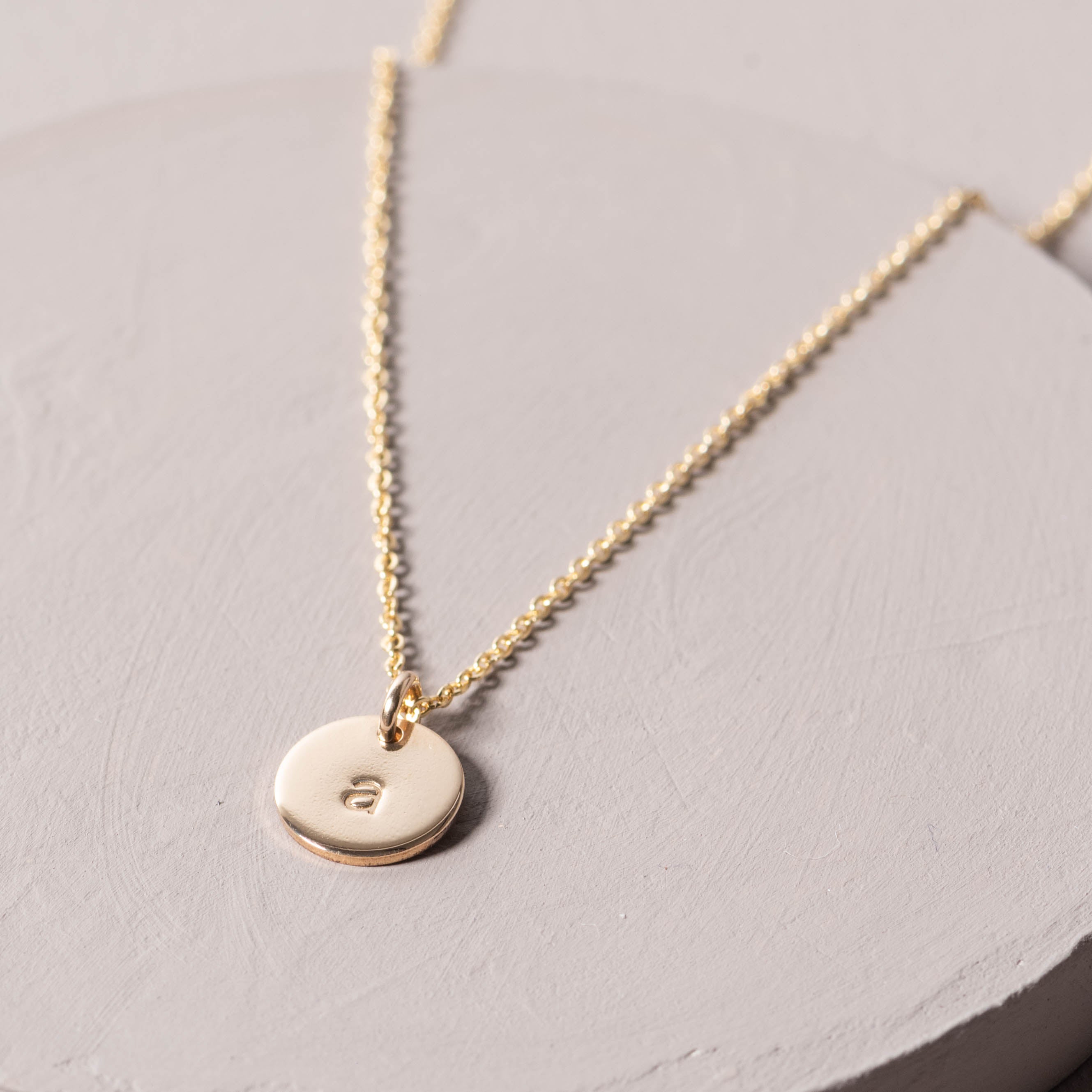 Magnoliass gold initial disc necklace