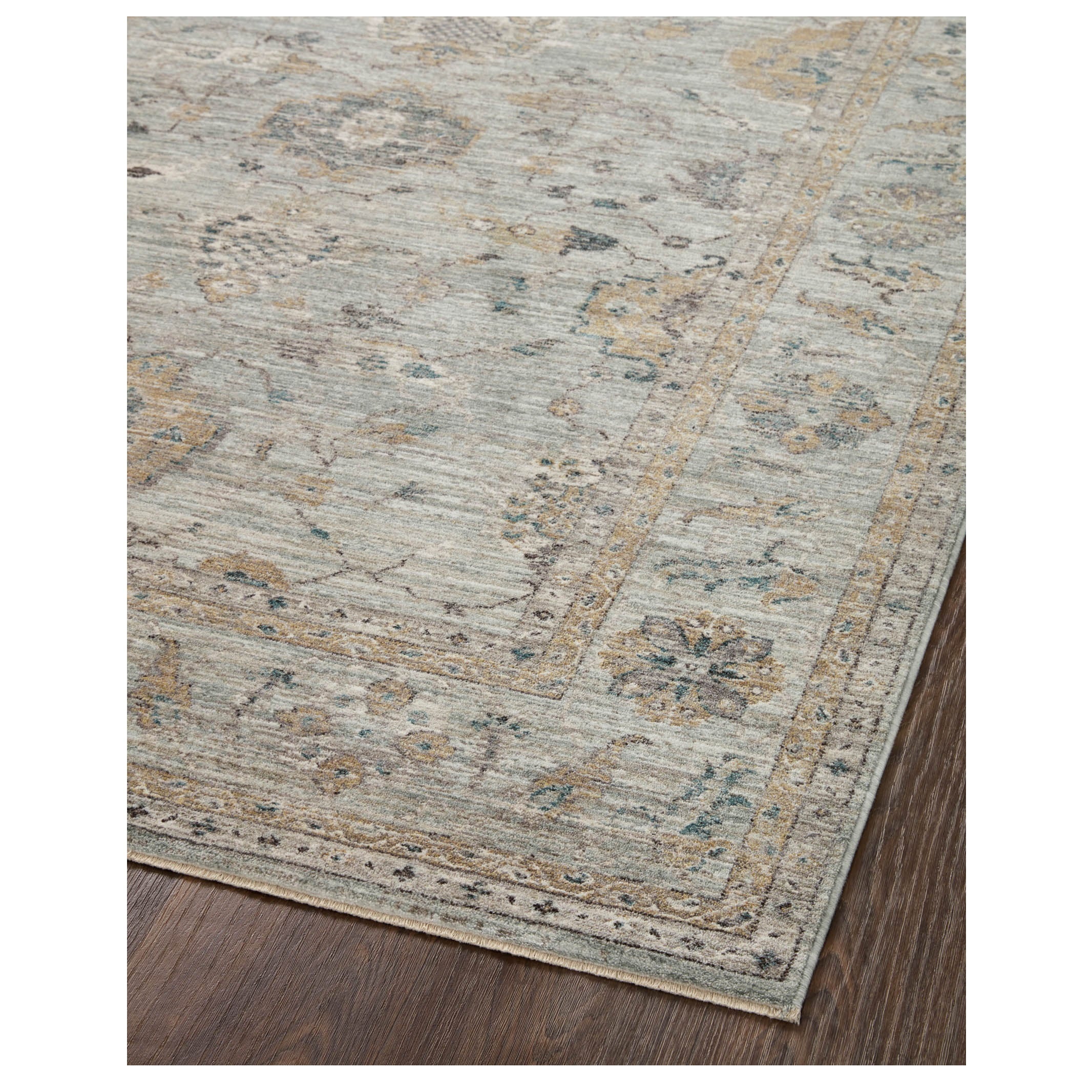 Millie Sky Gold Rug corner on wood floor 