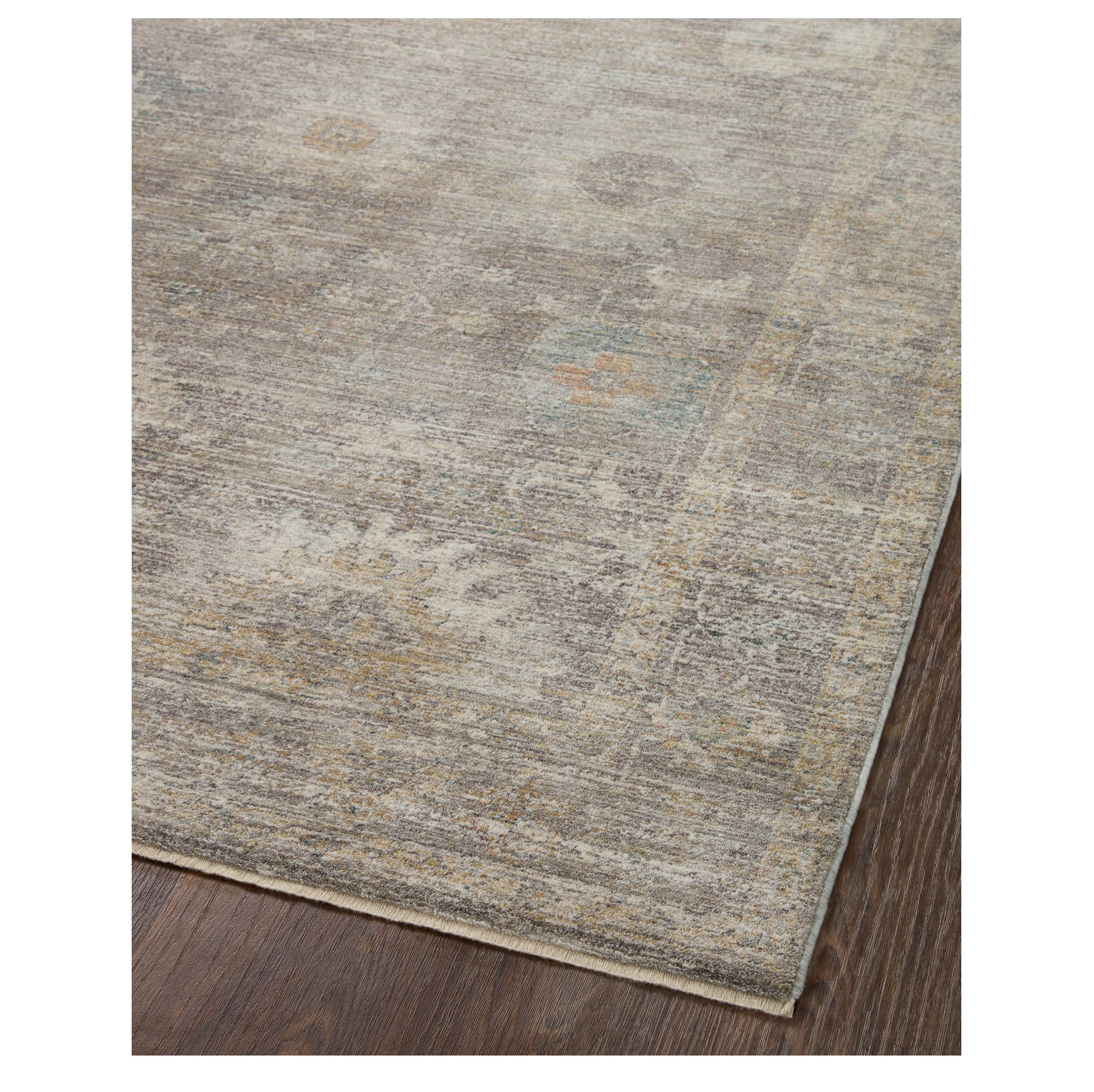 Millie Stone Natural Rug corner on wood floor
