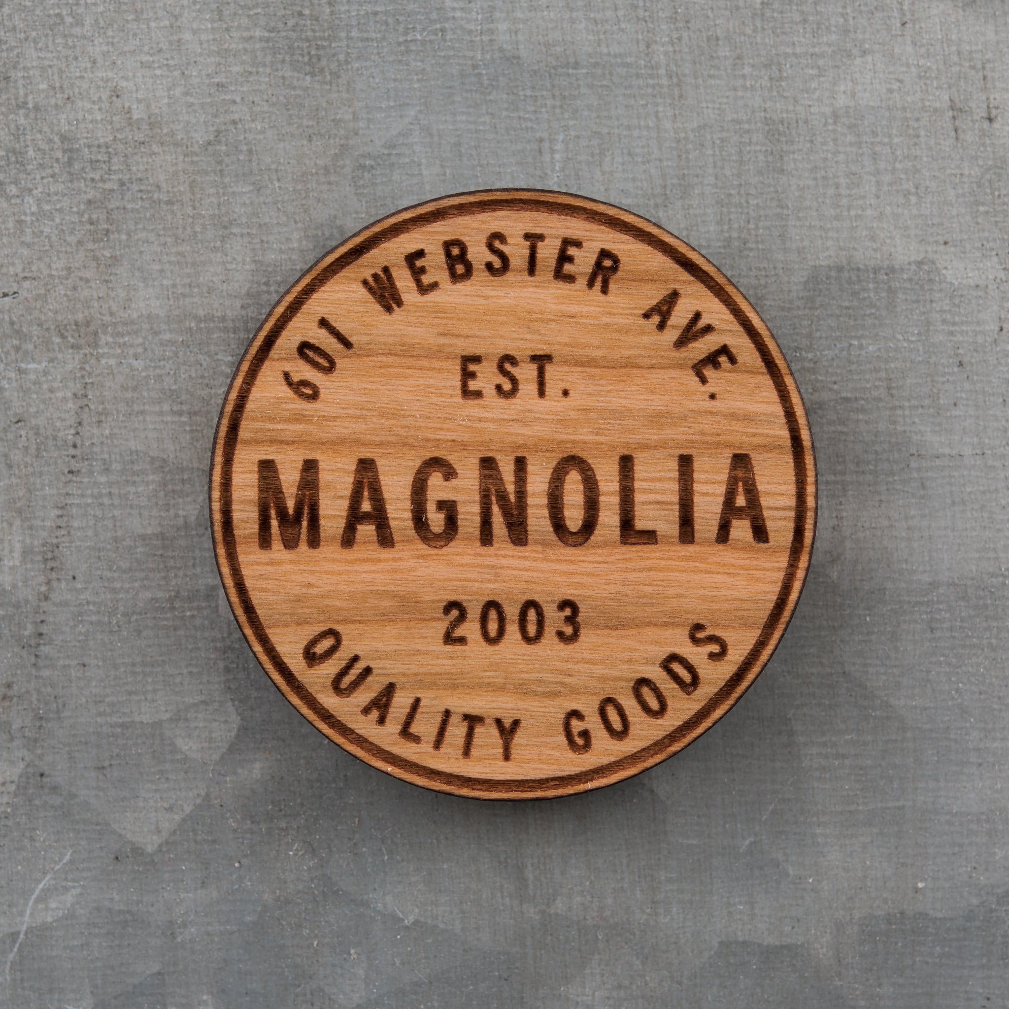 laser engraved wooden magnet with Magnoliass circle crest logo