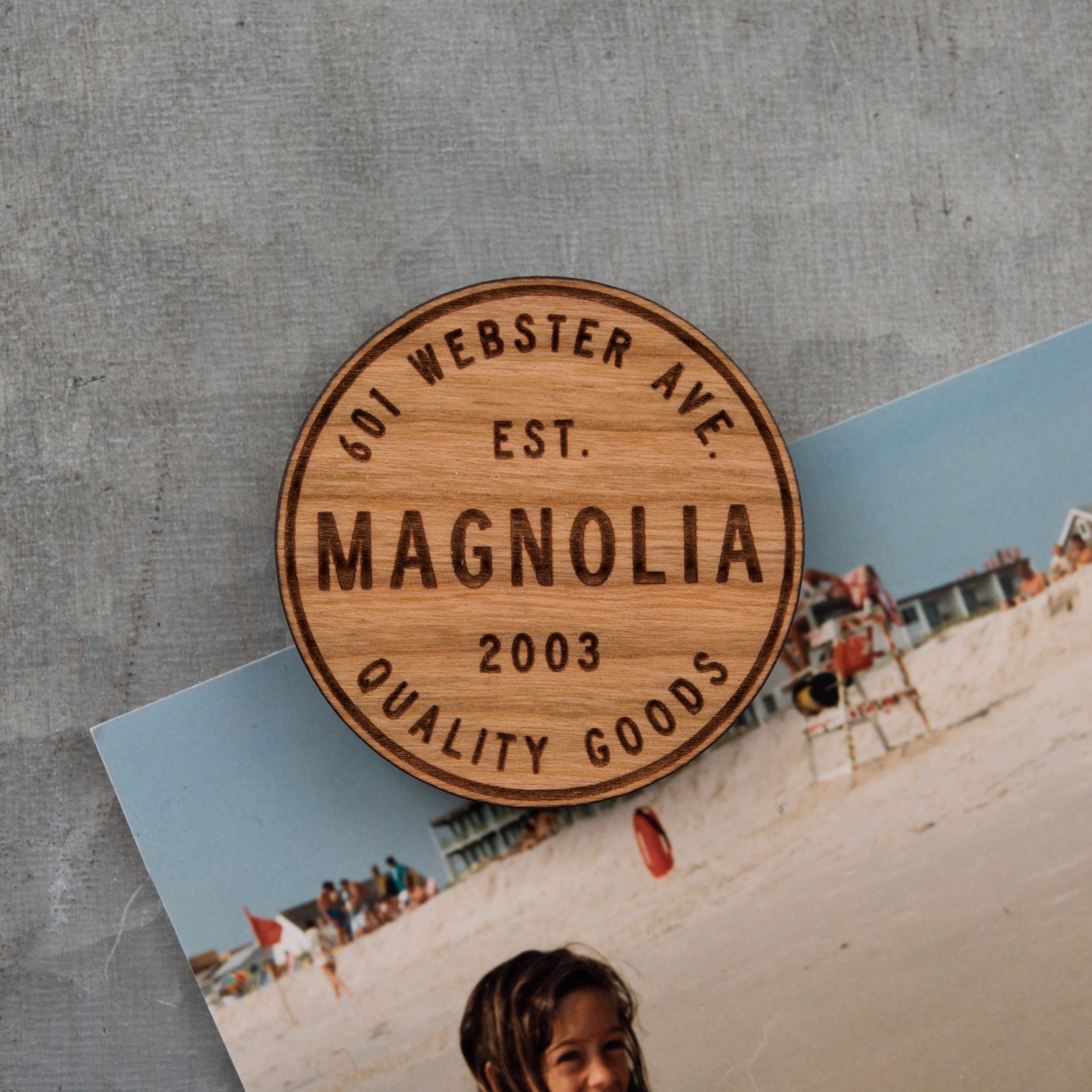 laser engraved wooden magnet with Magnoliass circle crest logo