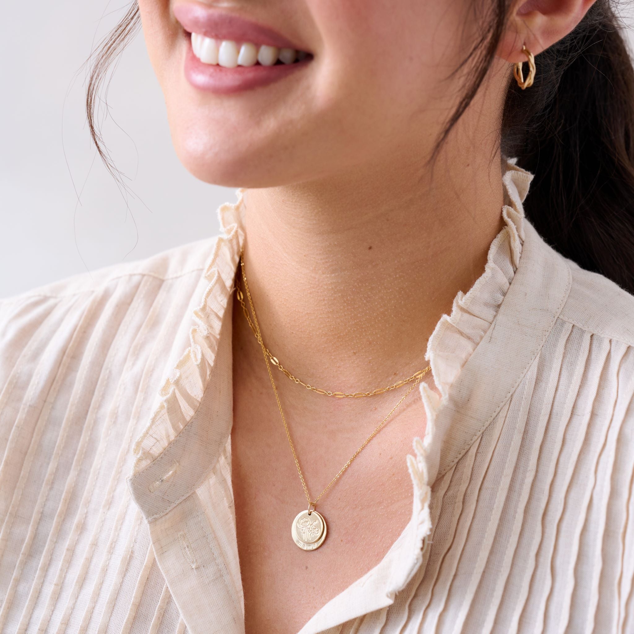 gold disc necklace with engraved flowers and mama