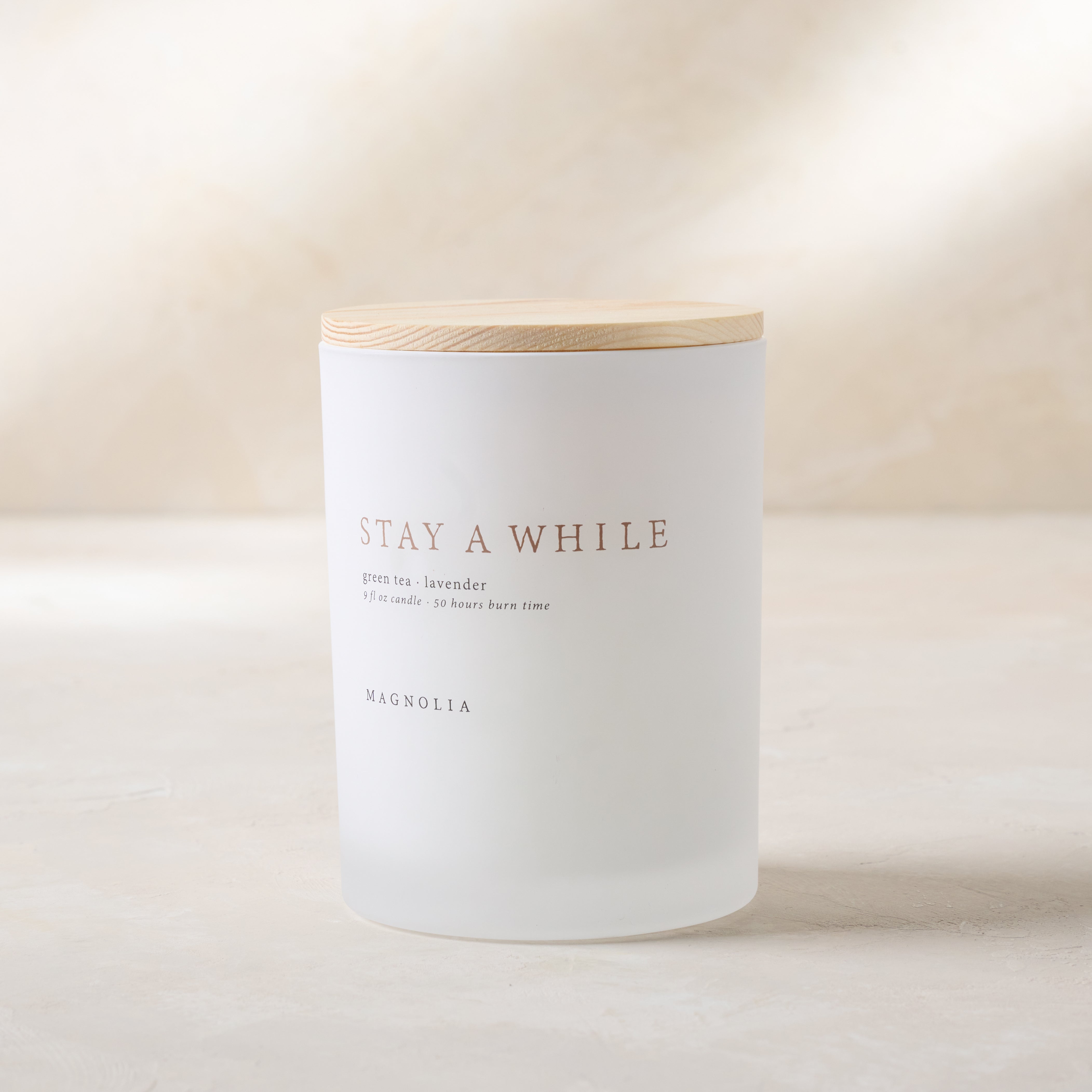 Magnoliass stay a while candle with wood lid notes scents of green tea and lavender