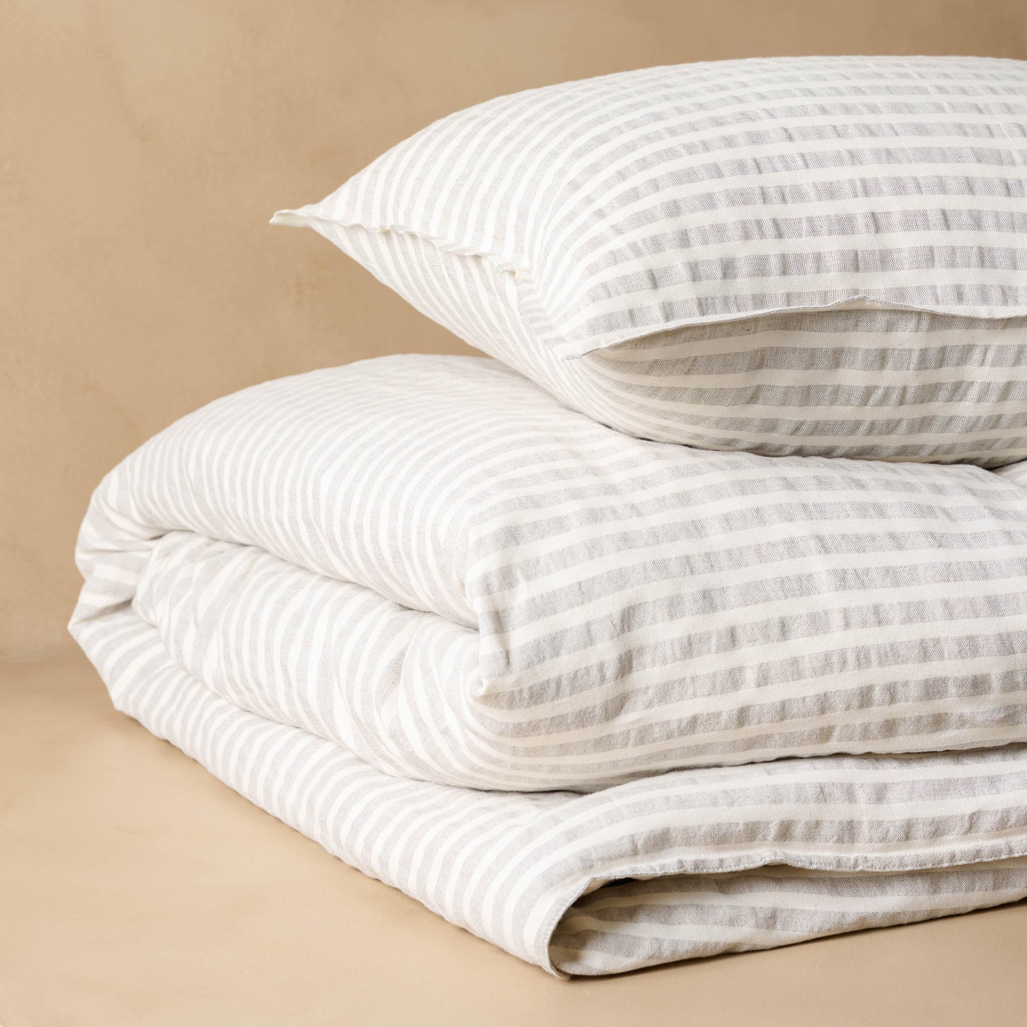 Shadow Grey + Oatmeal Stripe Linen Cotton Sham with matching duvet angled