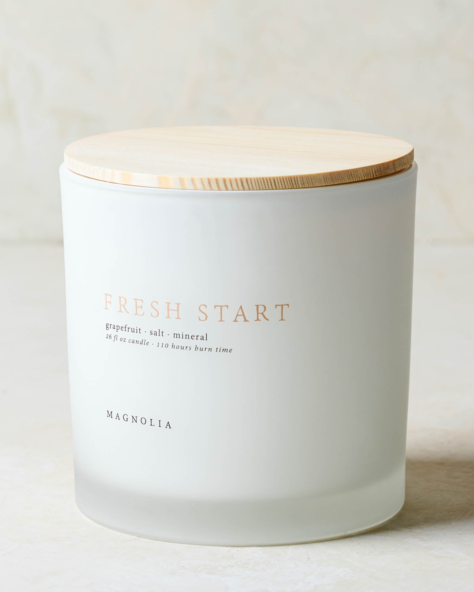 Magnoliass fresh start candle with wood lid notes scents of grapefruit salt and mineral