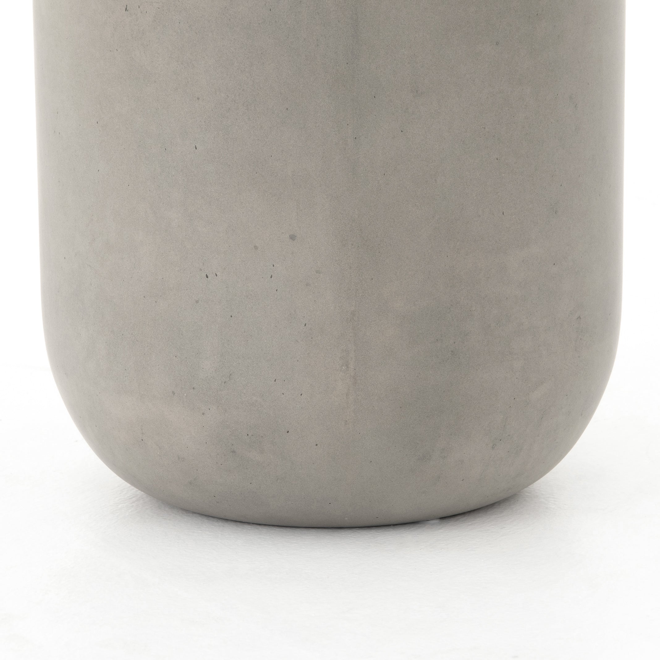 modern grey cylindrical end table with plaster finish