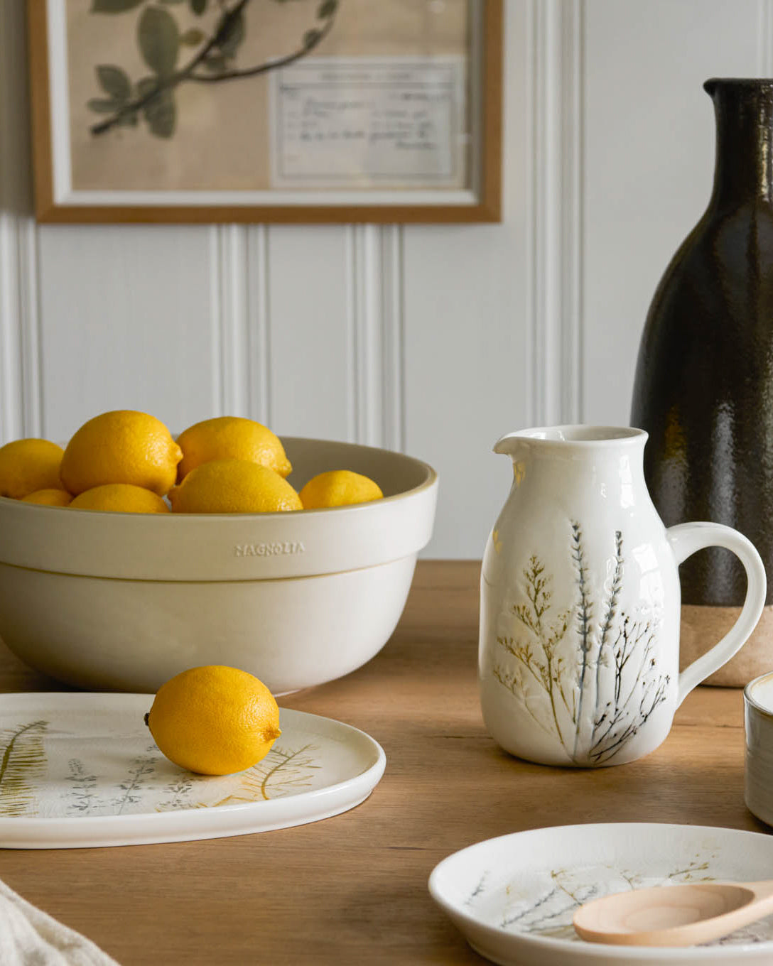 Pressed Floral Ceramic Pitcher on table next to bowl of oranges