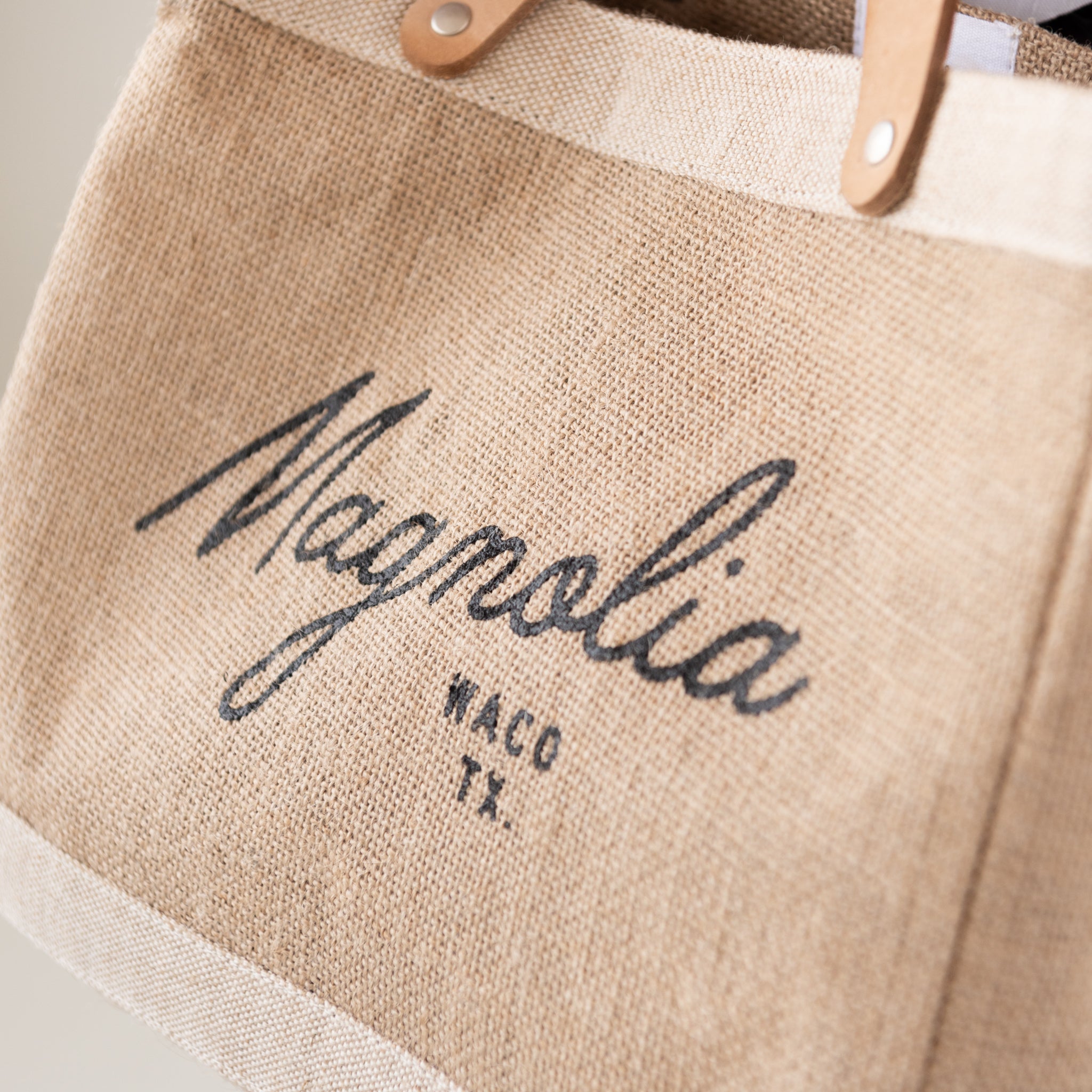burlap tote with leather handles with Magnoliass script logo