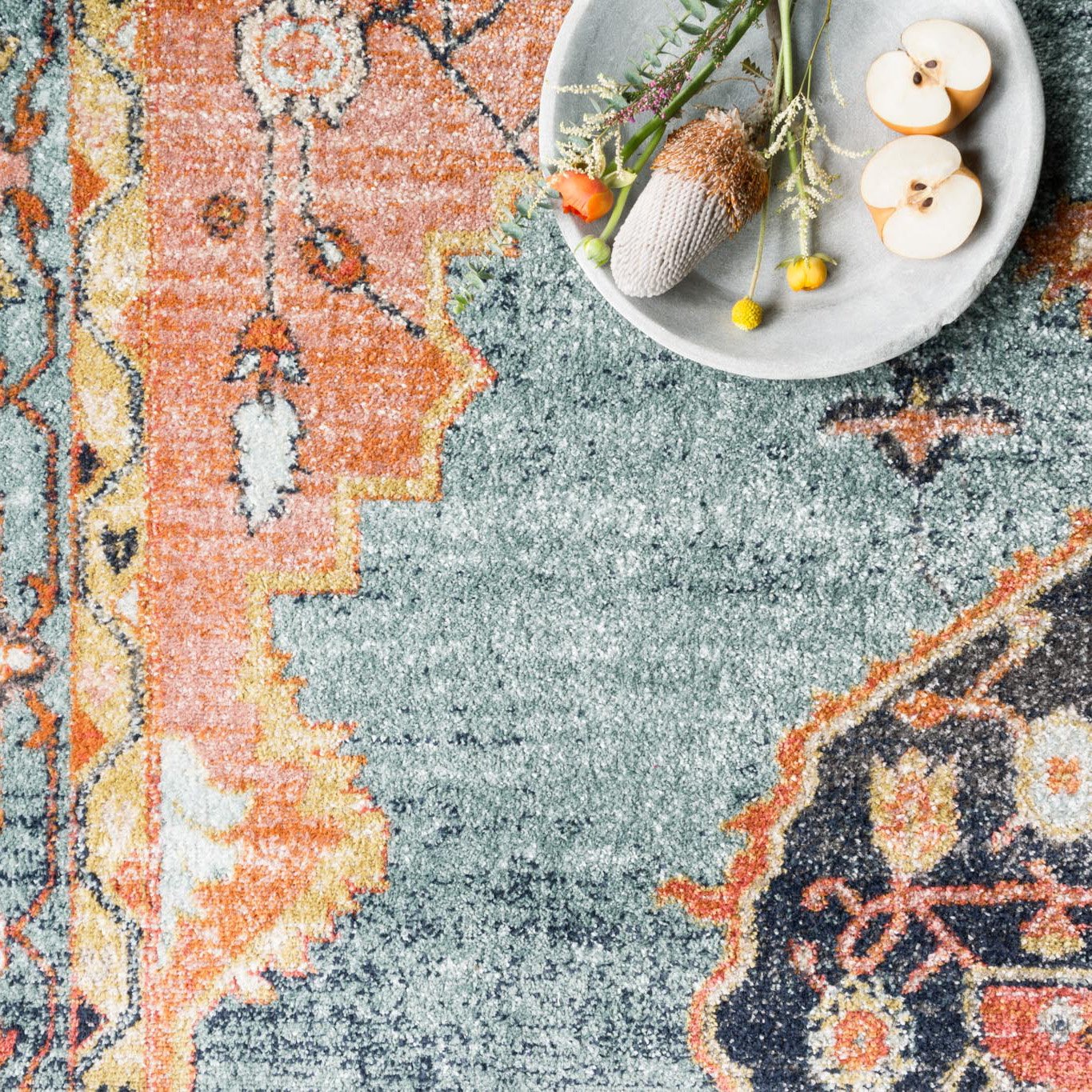 blue and orange traditional rug with multi-colored floral detail