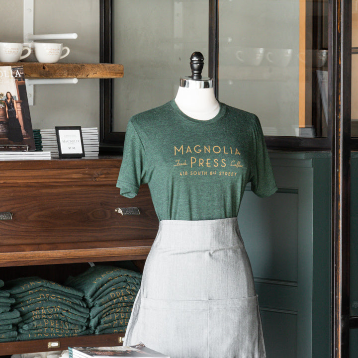 emerald green t-shirt with Magnoliass press coffee logo in gold across chest